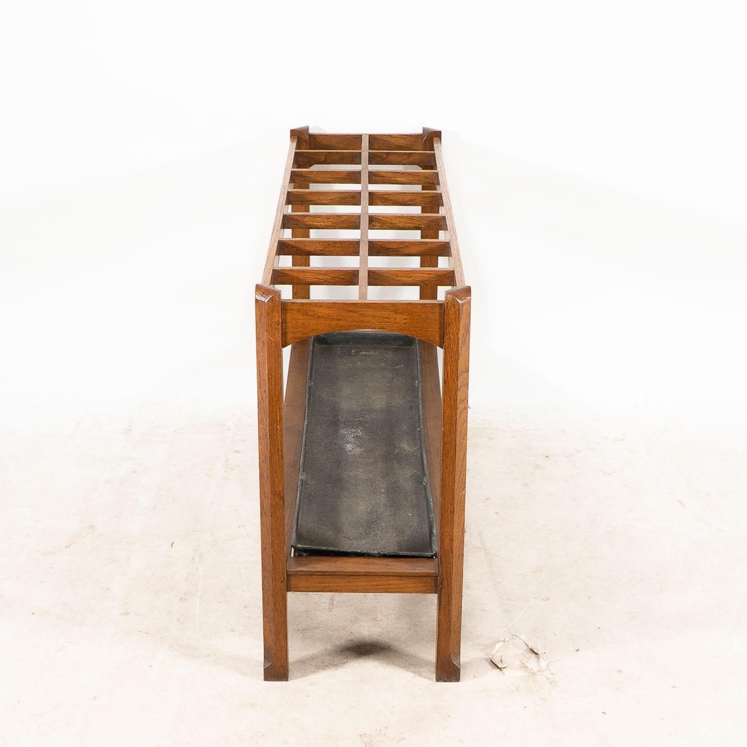 An Arts and Crafts oak stick and umbrella stand with fourteen sections For Sale 1