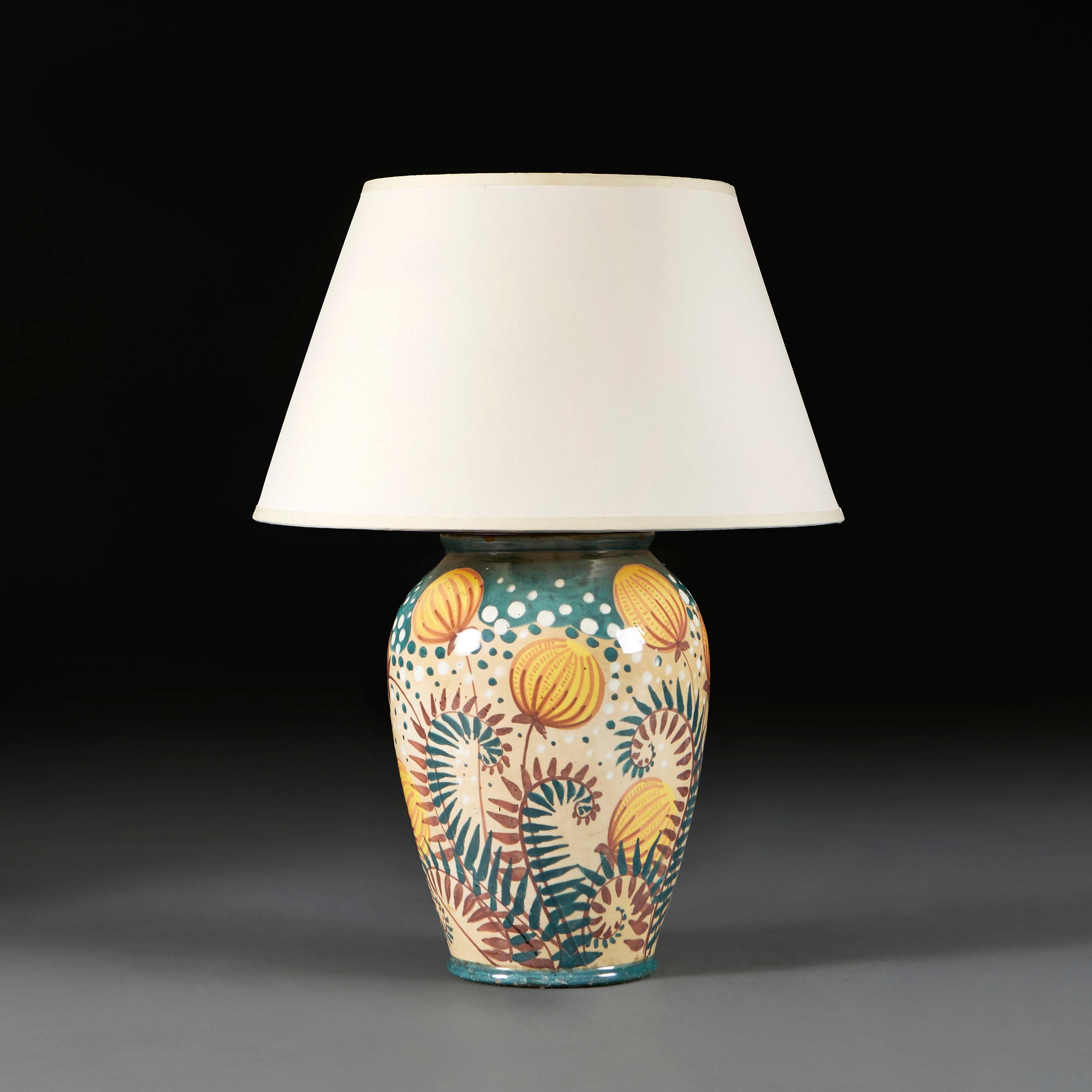 England, 1910

An Arts and Crafts ceramic urn vase decorated with underglaze paintings of unfurling fern leaves and yellow pomegranates fruits, now mounted as a lamp. 

Photographed with 16” diameter pale cream card Pembroke lampshade.

Currently