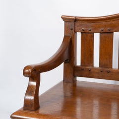 An Arts and Crafts super quality teak hall bench in the style of Arthur Simpson