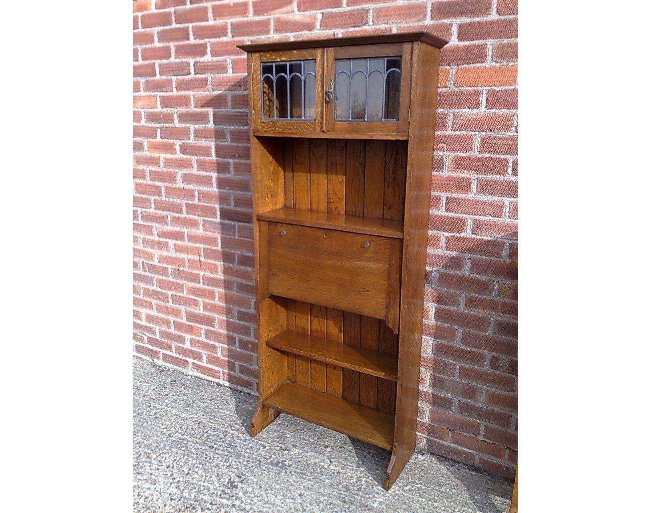 An Arts and Crafts tall oak bureau bookcase with leaded glass doors In Good Condition For Sale In London, GB