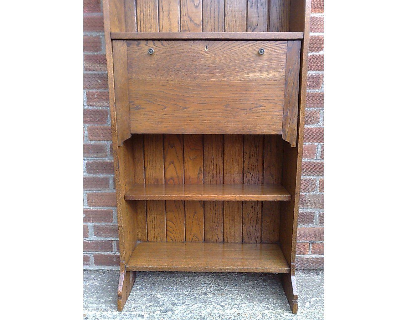 Oak An Arts and Crafts tall oak bureau bookcase with leaded glass doors For Sale