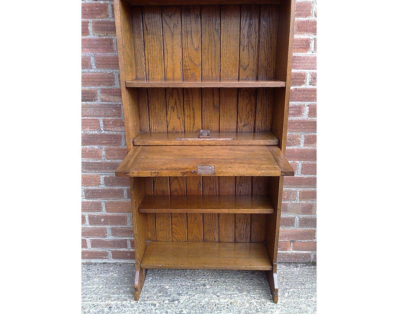 An Arts and Crafts tall oak bureau bookcase with leaded glass doors For Sale 1