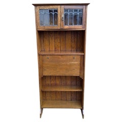 Antique An Arts and Crafts tall oak bureau bookcase with leaded glass doors