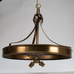 An Arts & Craft ceiling light with stylized petals & a circular brass ring