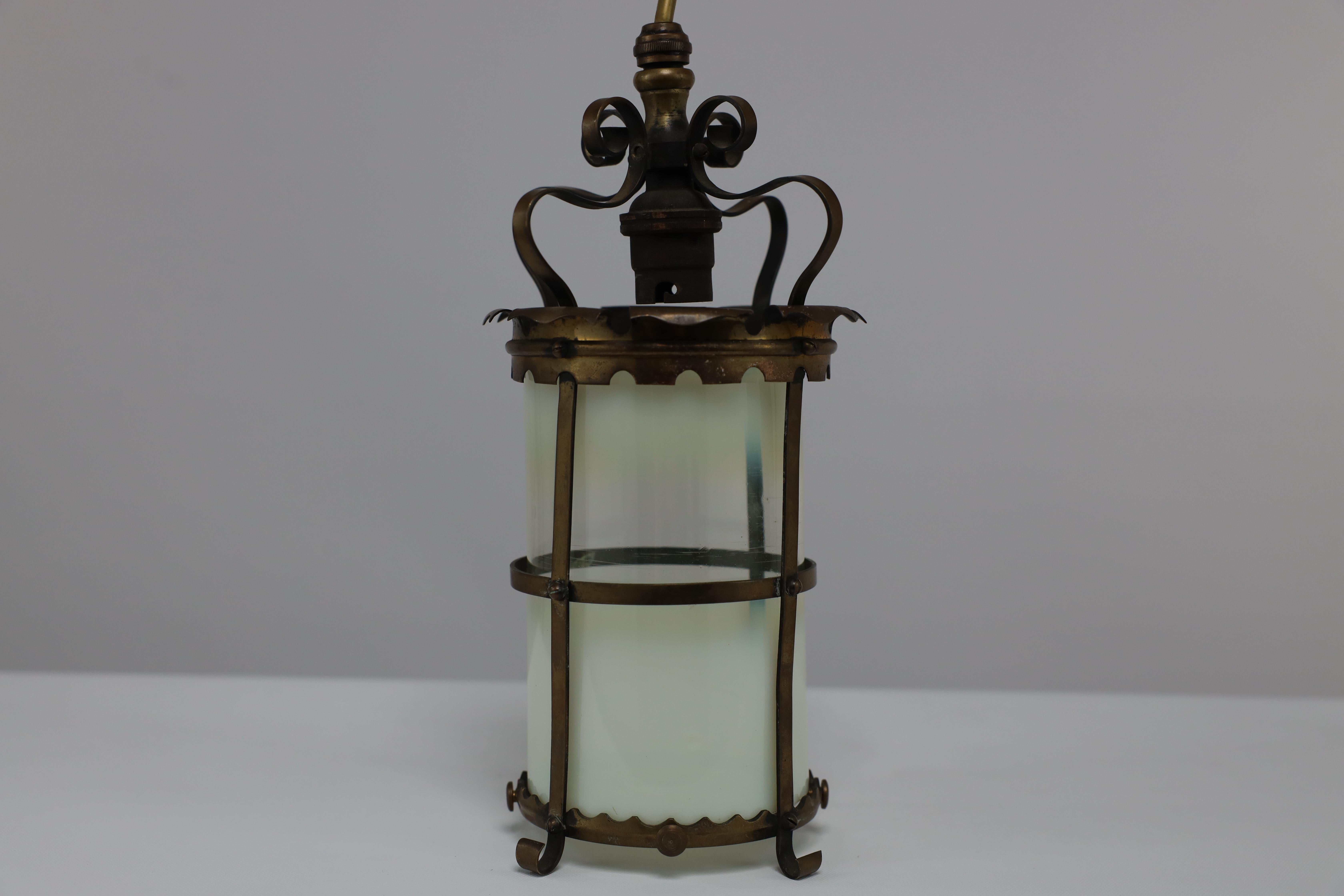 An Arts & Crafts brass ceiling lantern with the original vaseline shade 5