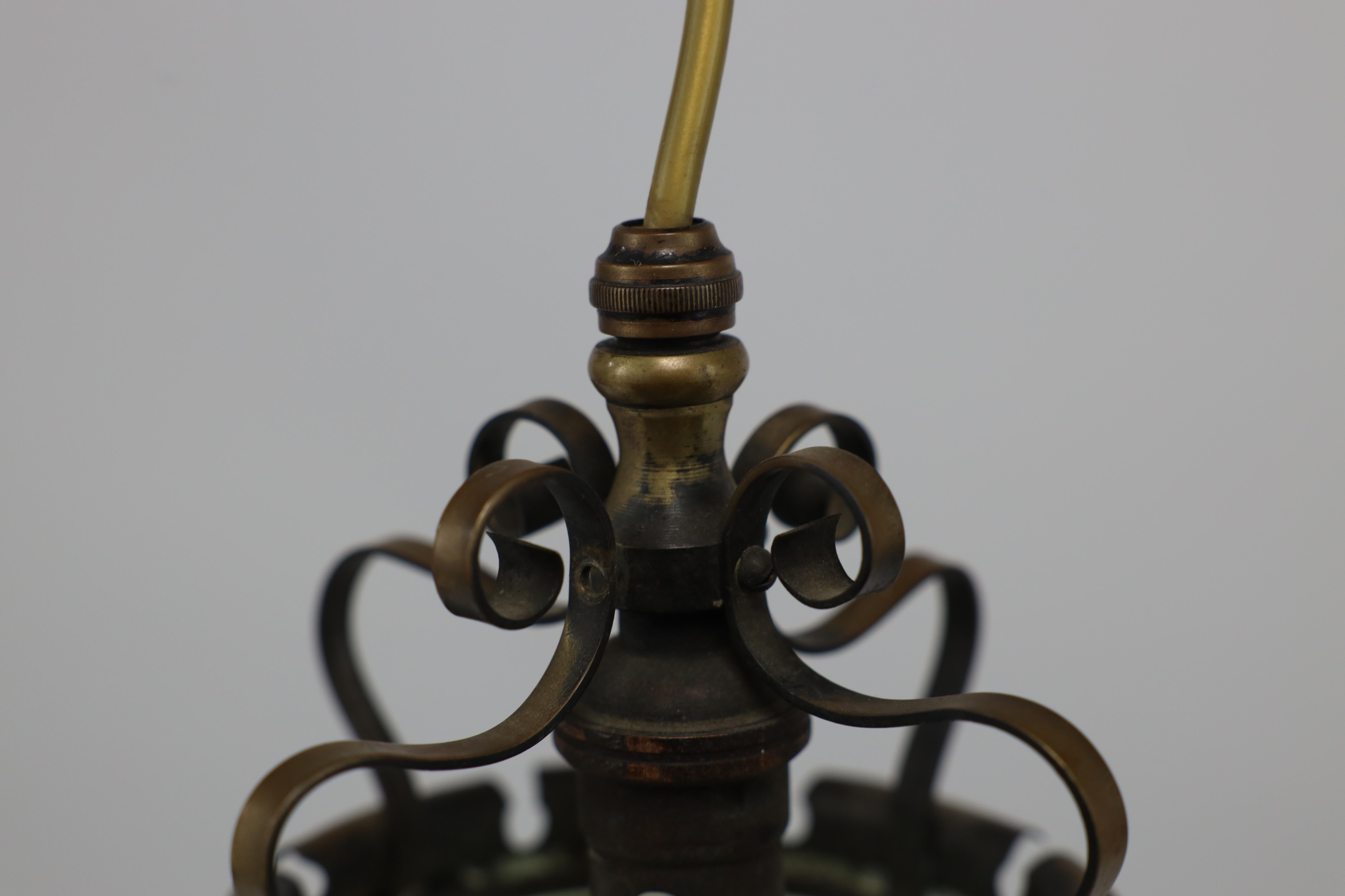 An Arts & Crafts brass ceiling lantern with the original vaseline shade 9