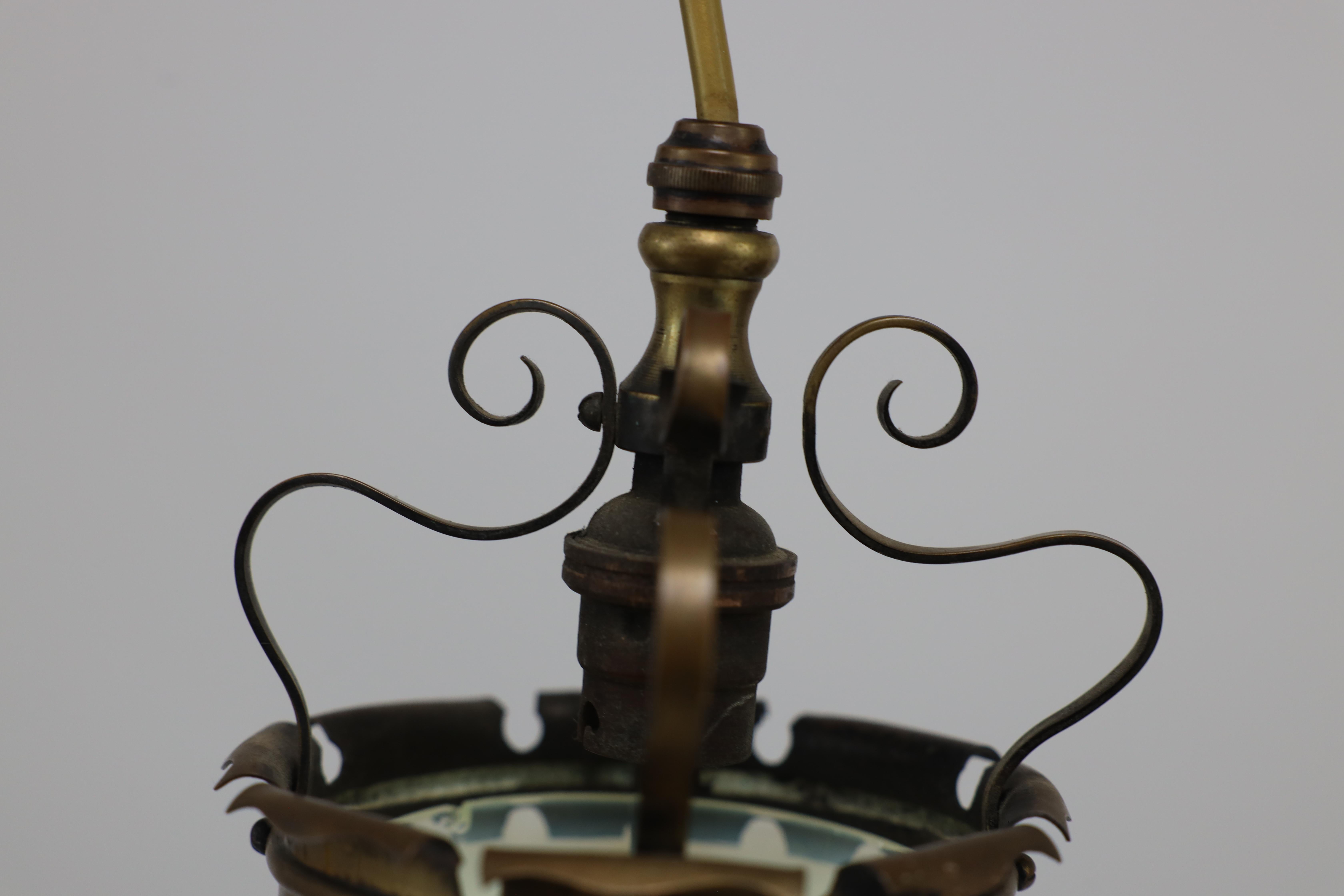 An Arts & Crafts brass ceiling lantern with the original vaseline shade 10