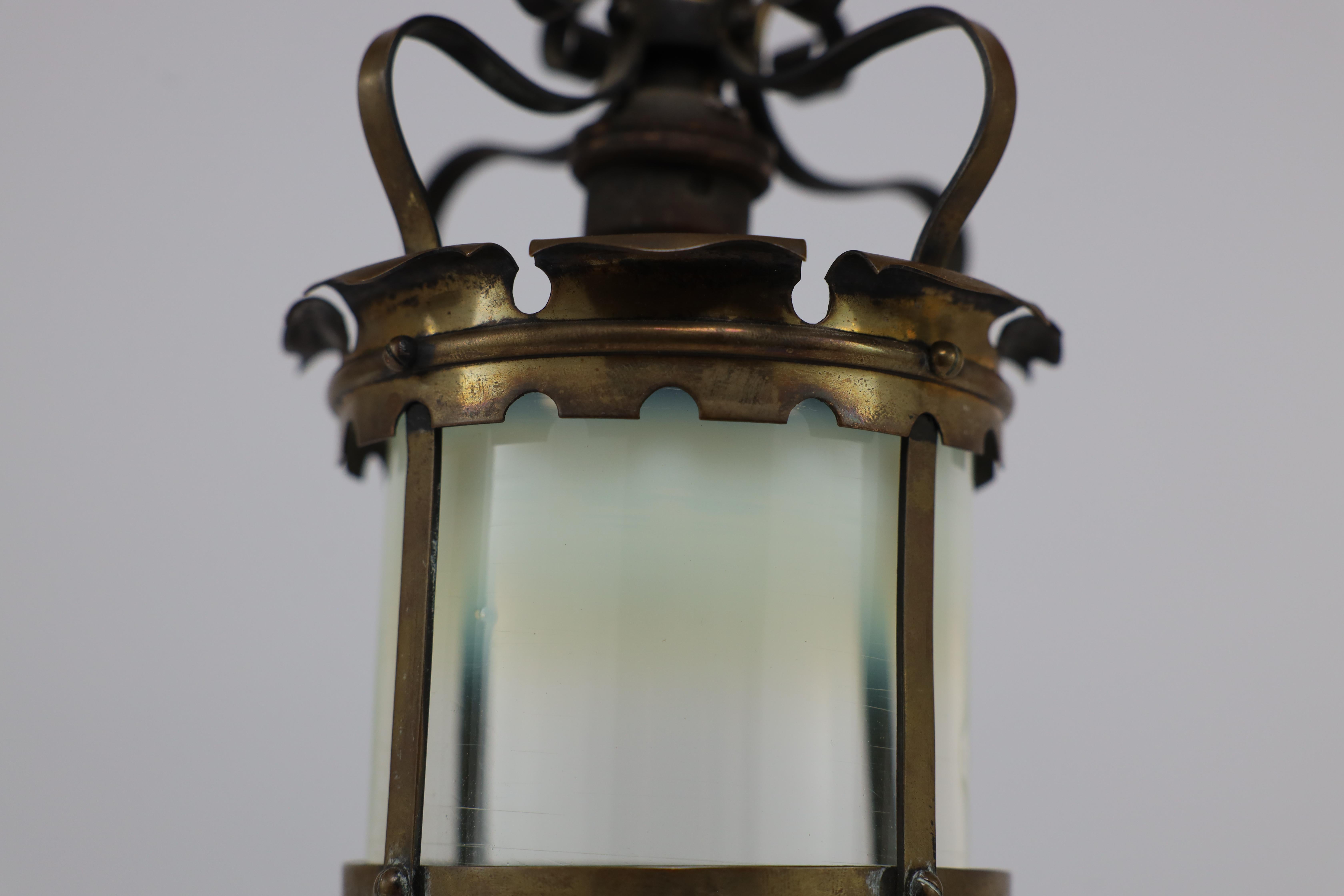 An Arts & Crafts brass ceiling lantern with the original vaseline shade 12