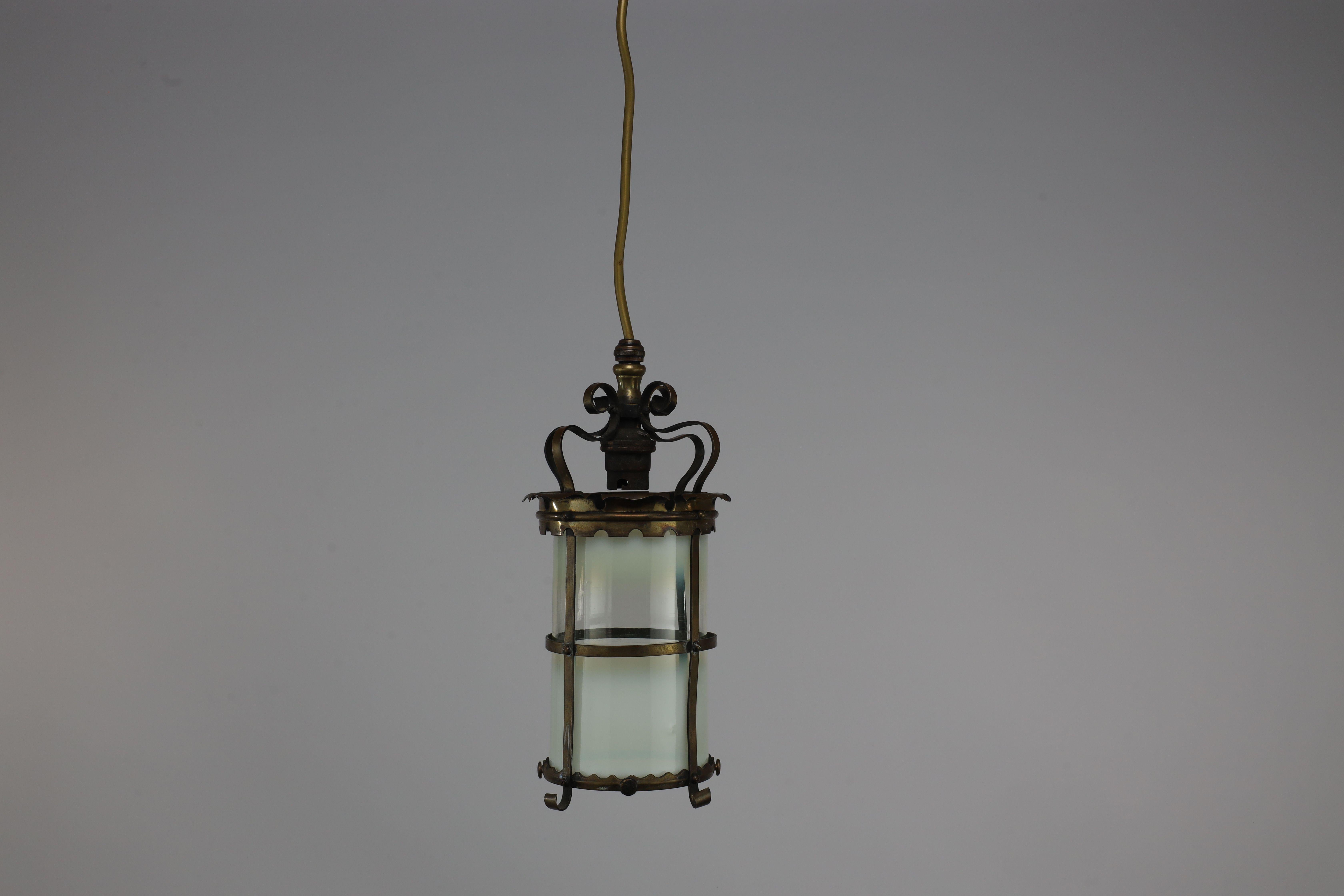 A brass ceiling lantern, hand formed with a Vaseline glass liner. Re-wired and ready to use.