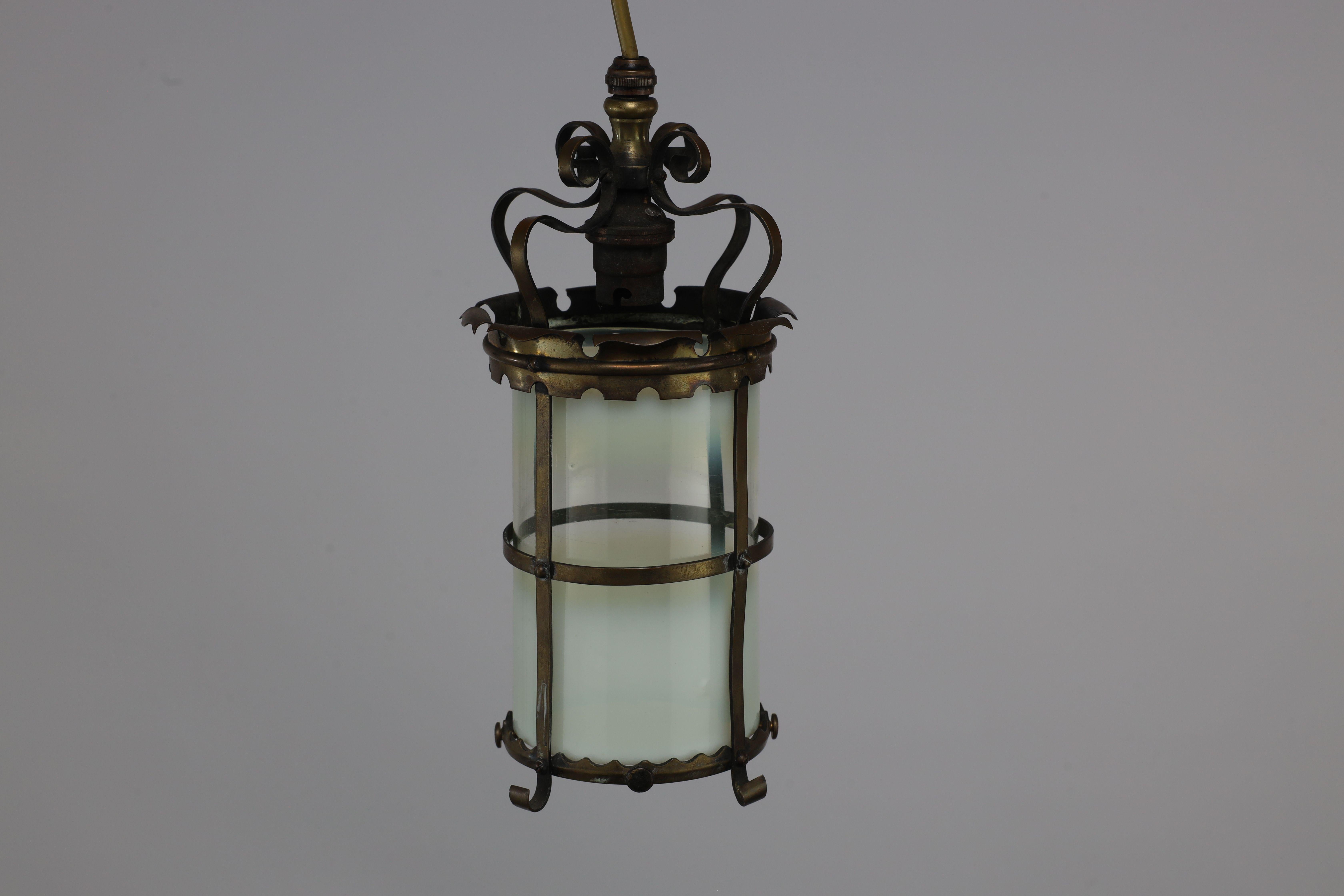 English An Arts & Crafts brass ceiling lantern with the original vaseline shade