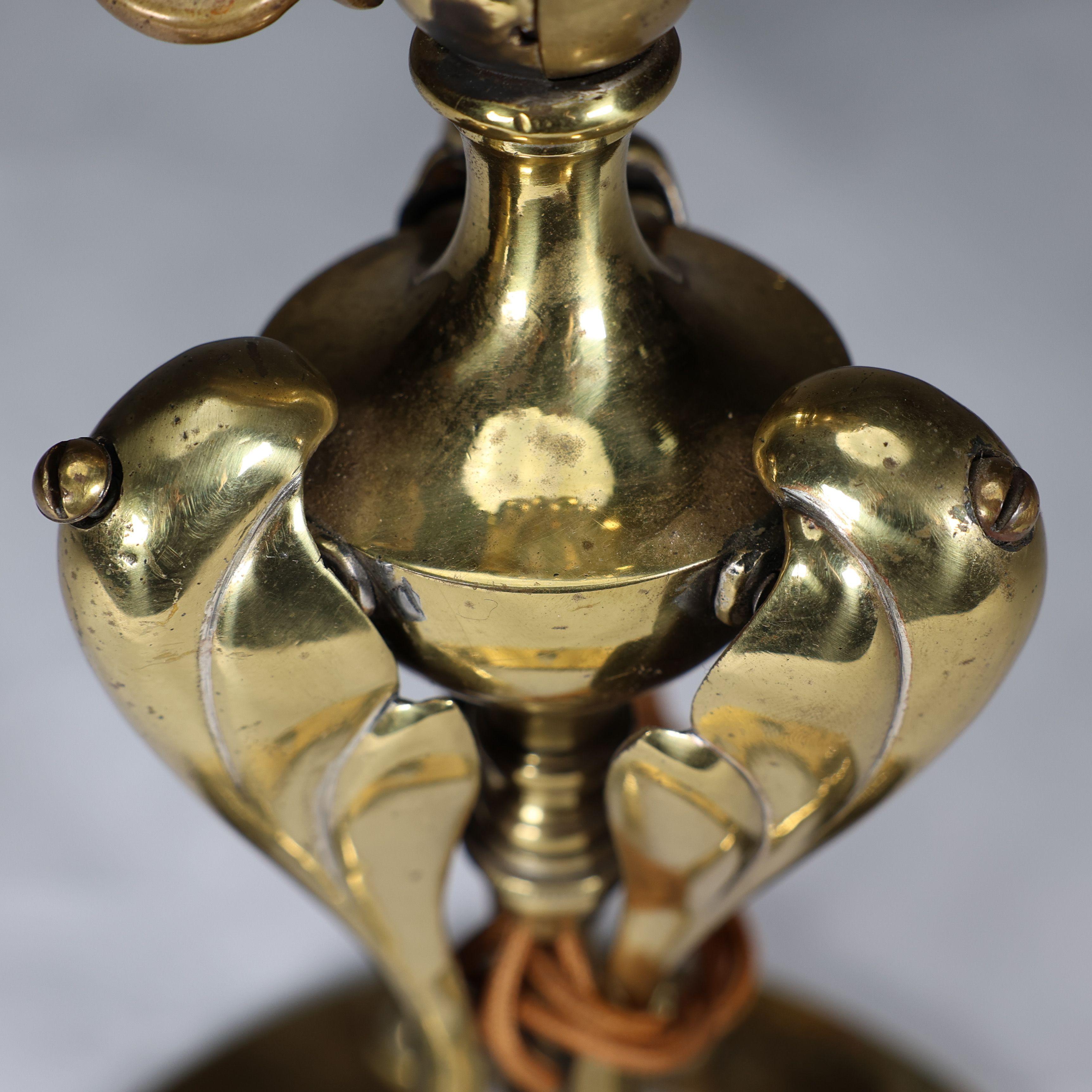 Early 20th Century An Arts & Crafts brass table lamp tulip shaped with heart cut-outs to the base For Sale
