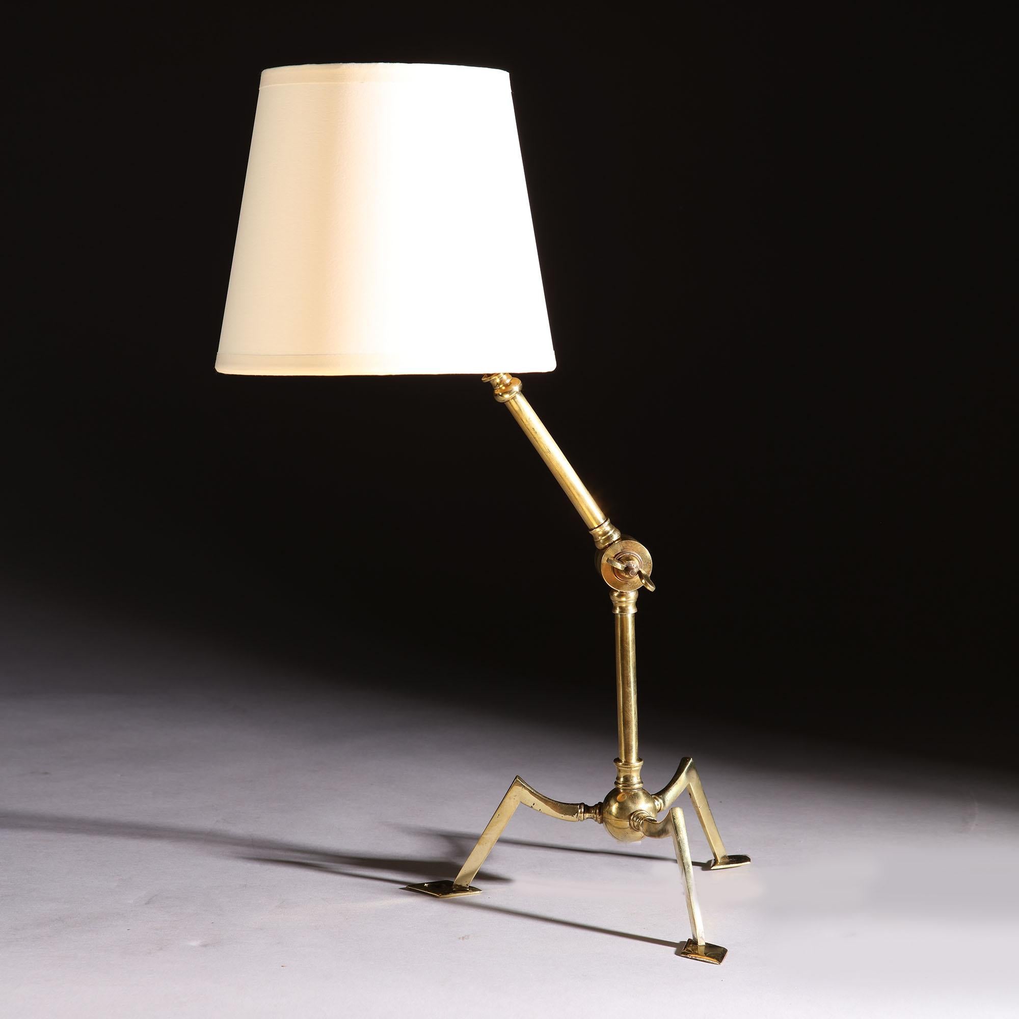 An Arts & Crafts brass tripod lamp by W.A.S Benson, with adjustable arm, adaptable for tabletop or wall-mounted position. 

Benson stamp to the underside of one foot.

Please note: Lampshade not included.

Currently wired for the UK. Please