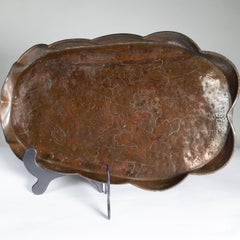 An Arts & Crafts copper tray decorated with swimming fishes & folded wavy edges
