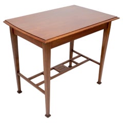 An Arts & Crafts Glasgow School walnut side table w. moulded subtly curving edge