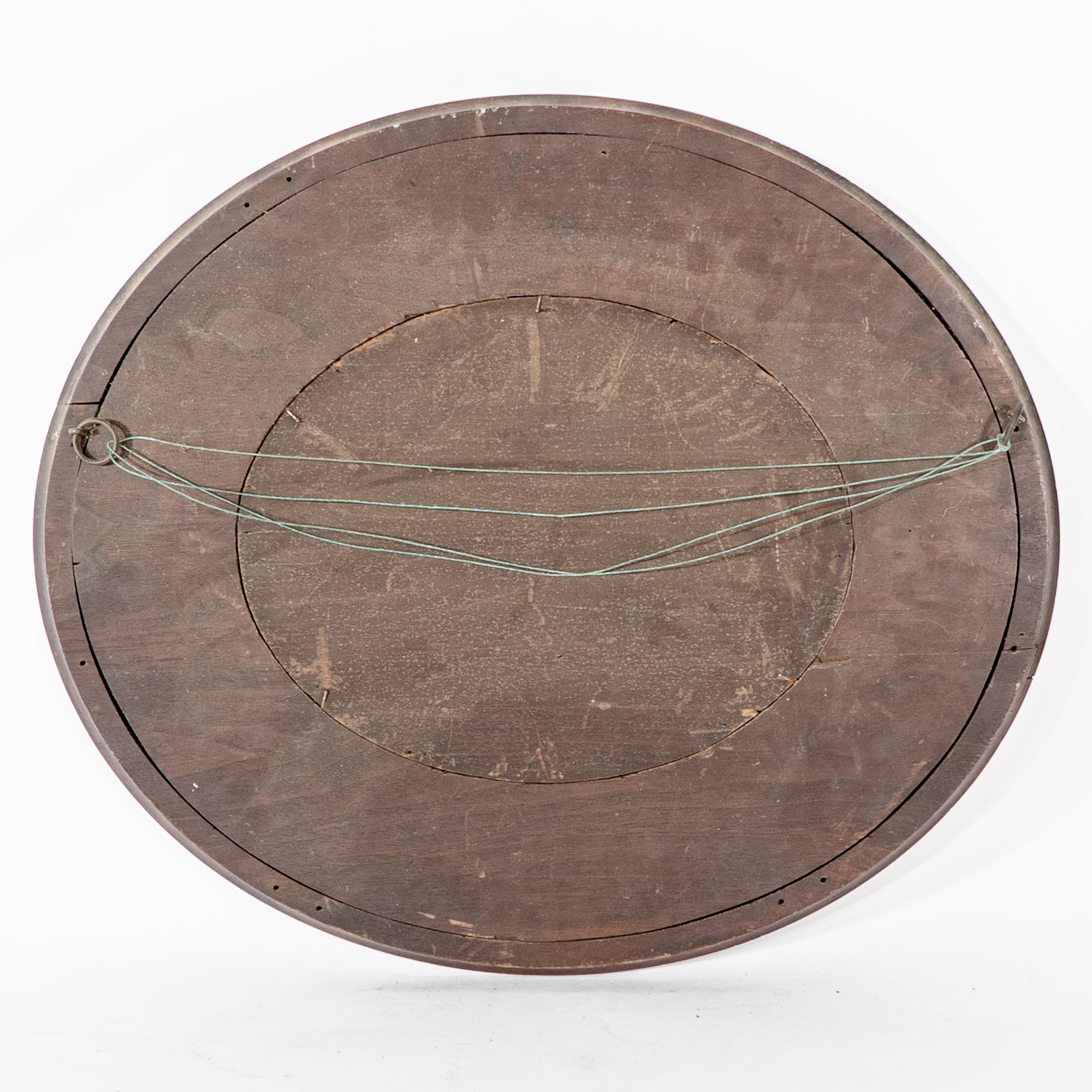 An Arts & Crafts walnut circular mirror with stylized floral carved decoration For Sale 2