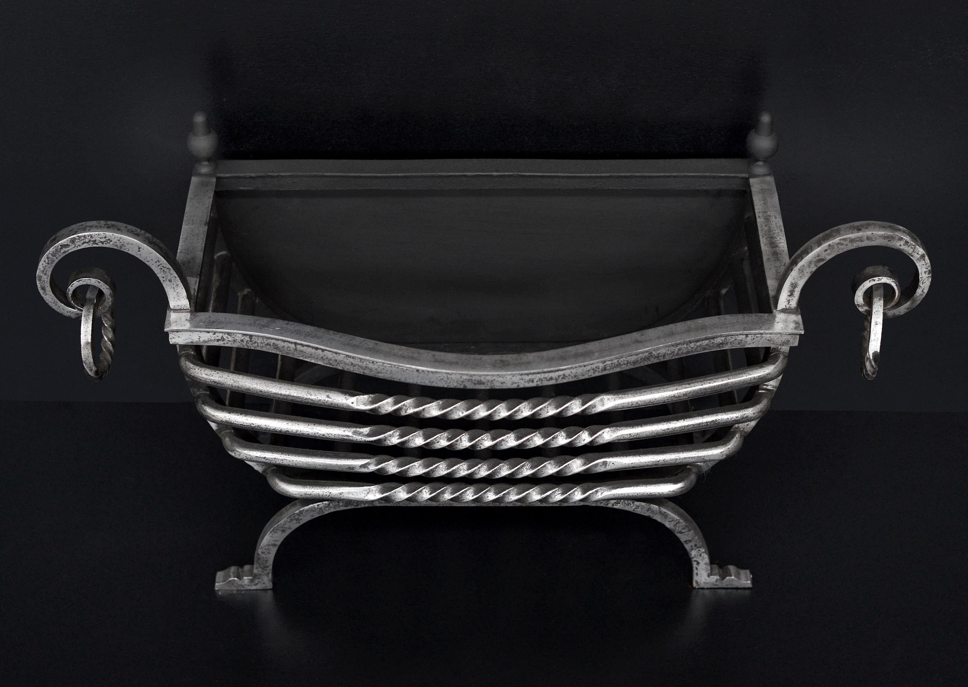 An Arts and Crafts wrought iron firebasket with barley twist shaped front bars and rings to scrolled arms, Circa 1900.

Width At Front:	717 mm      	28 ¼