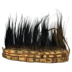 Un copricapo Asmat decorato con piume di cinghiale