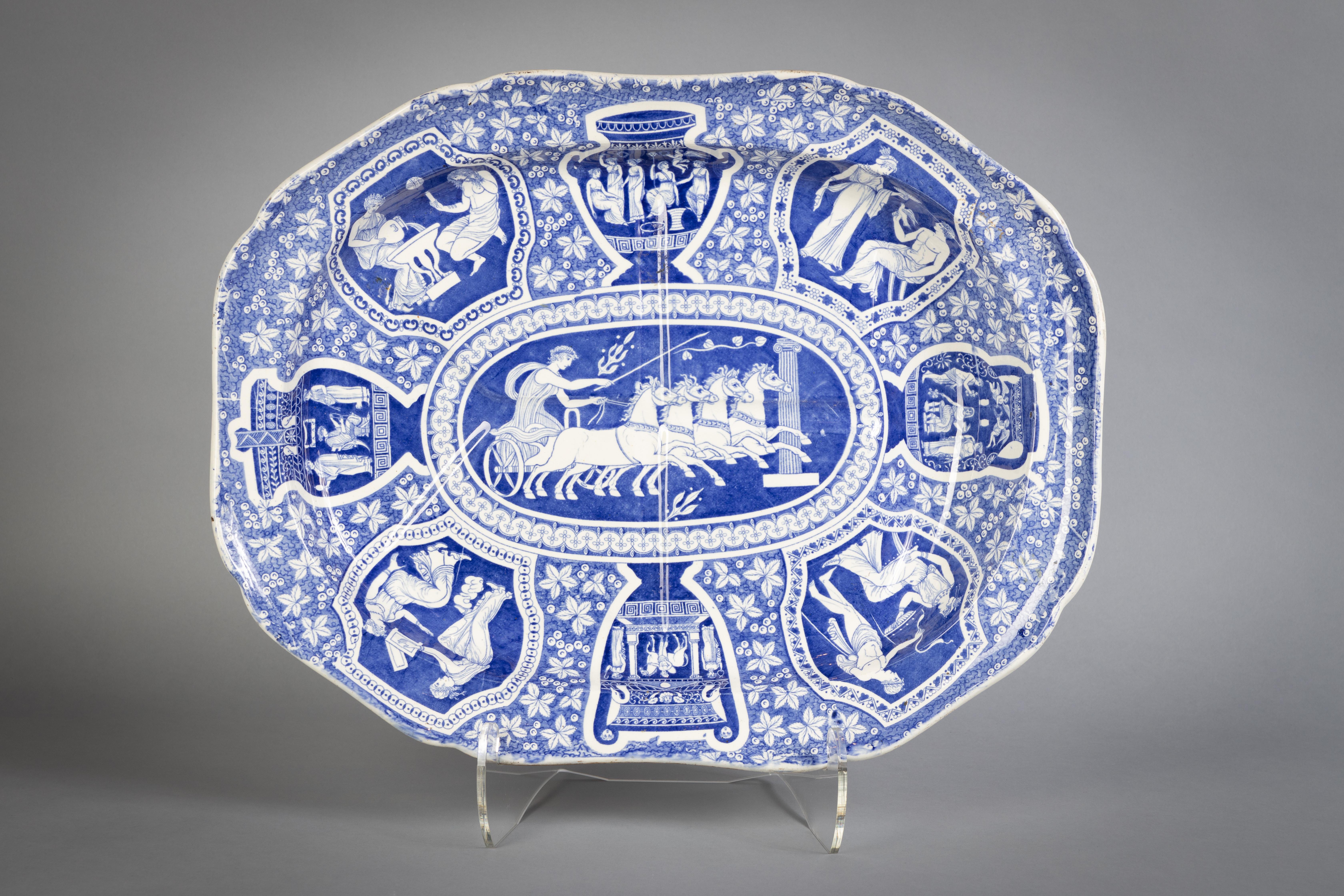 UPDATE: SOLD 12 dinner plates, 10 soup plates, one well-and-tree platter. Each piece transfer-printed in blue with panels of classical figures and vases, comprising: a soup tureen and cover, a {21