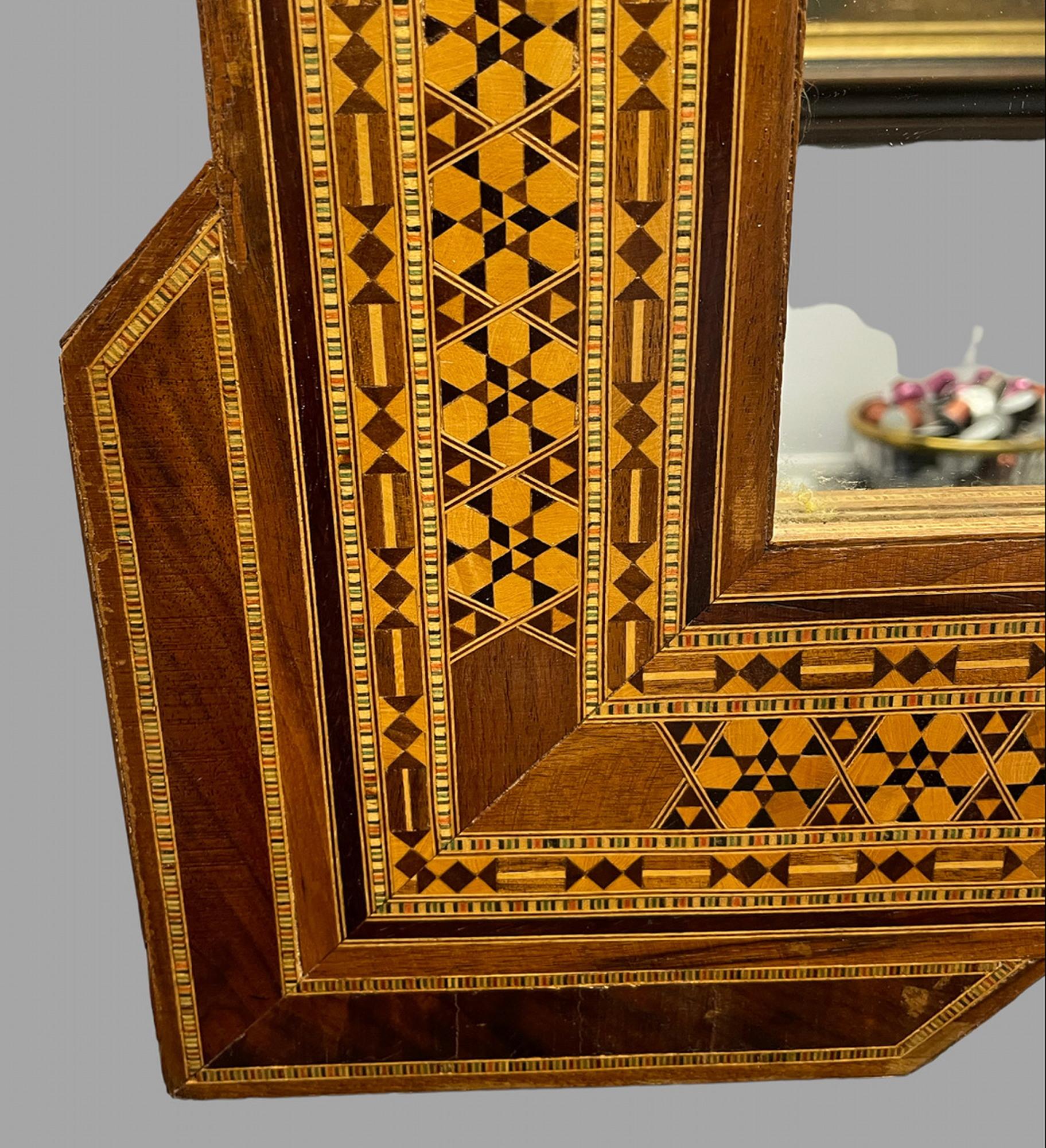 Un attrayant miroir mural en céramique de Damas avec une plaque rectangulaire et un cadre incrusté de manière typique.