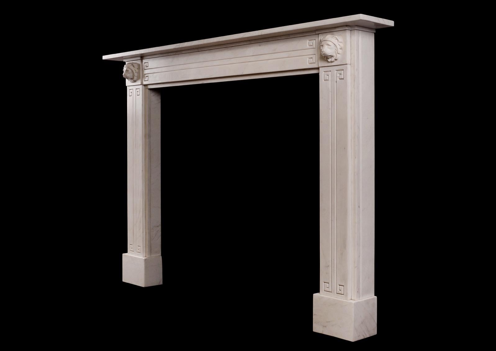 An attractive English Regency fireplace in white marble. The jambs and frieze with Greek key motif, the end blockings with carved lion's masks with moulded shelf above. A fine quality copy of a period original. N.B. May be subject to an extended