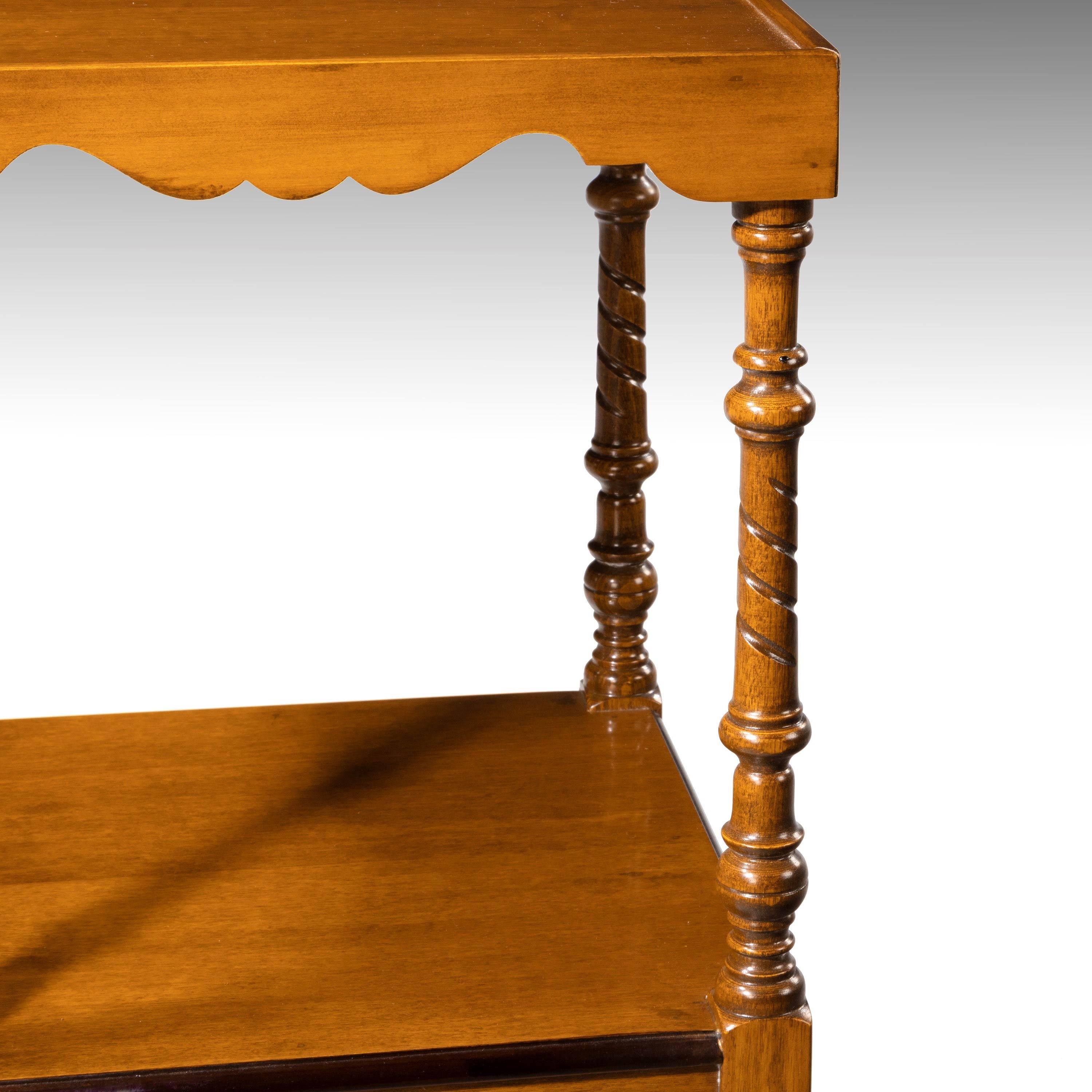 An attractive mahogany two-tiered nightstand on finely turned supports with spiral sections. Single drawer with a replacement period handle. 
Excellent overall condition. 
        