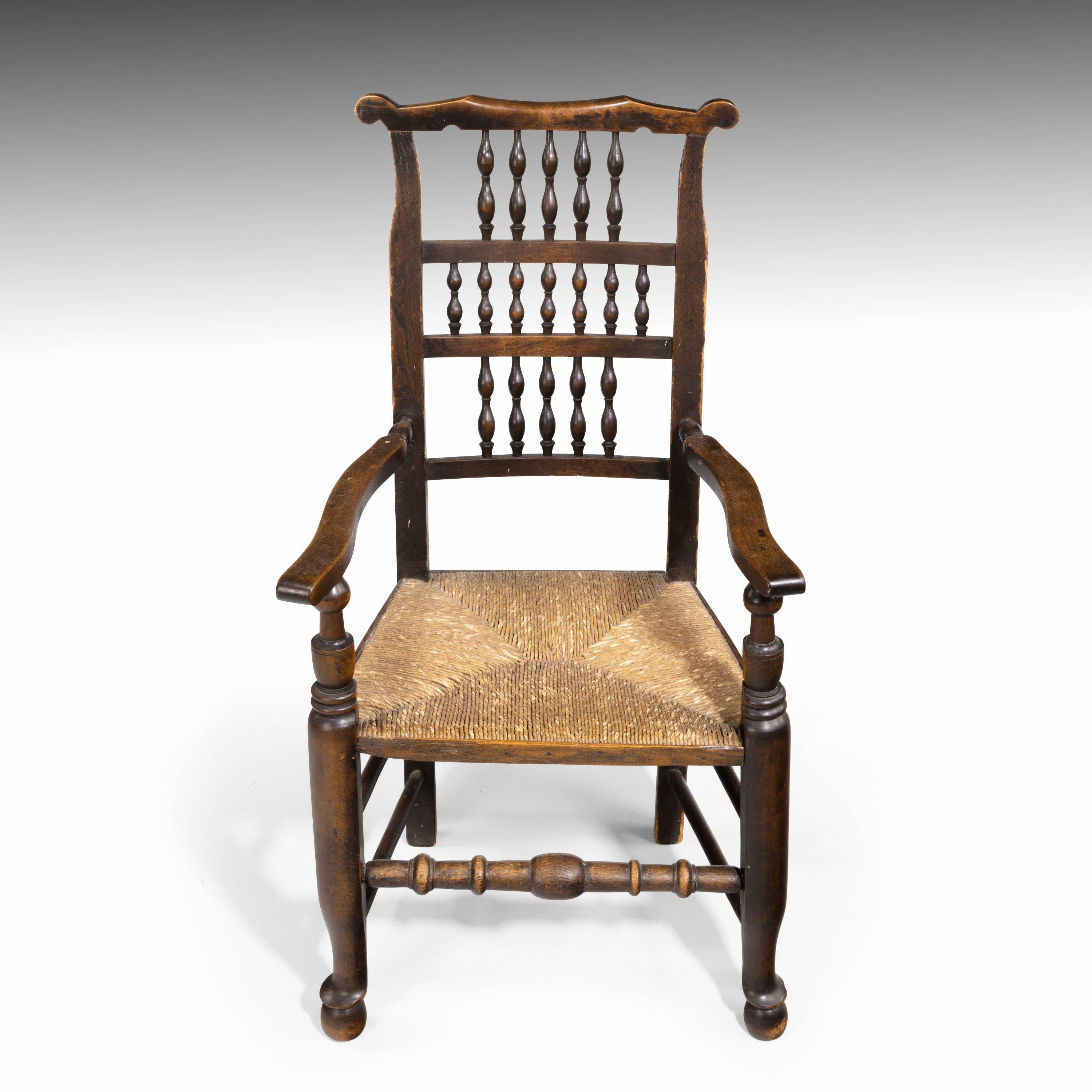 An attractive elm spindle back armchair with a rush seat, mid-19th century. Excellent overall conditional and patina, measures: Seat height 17.5