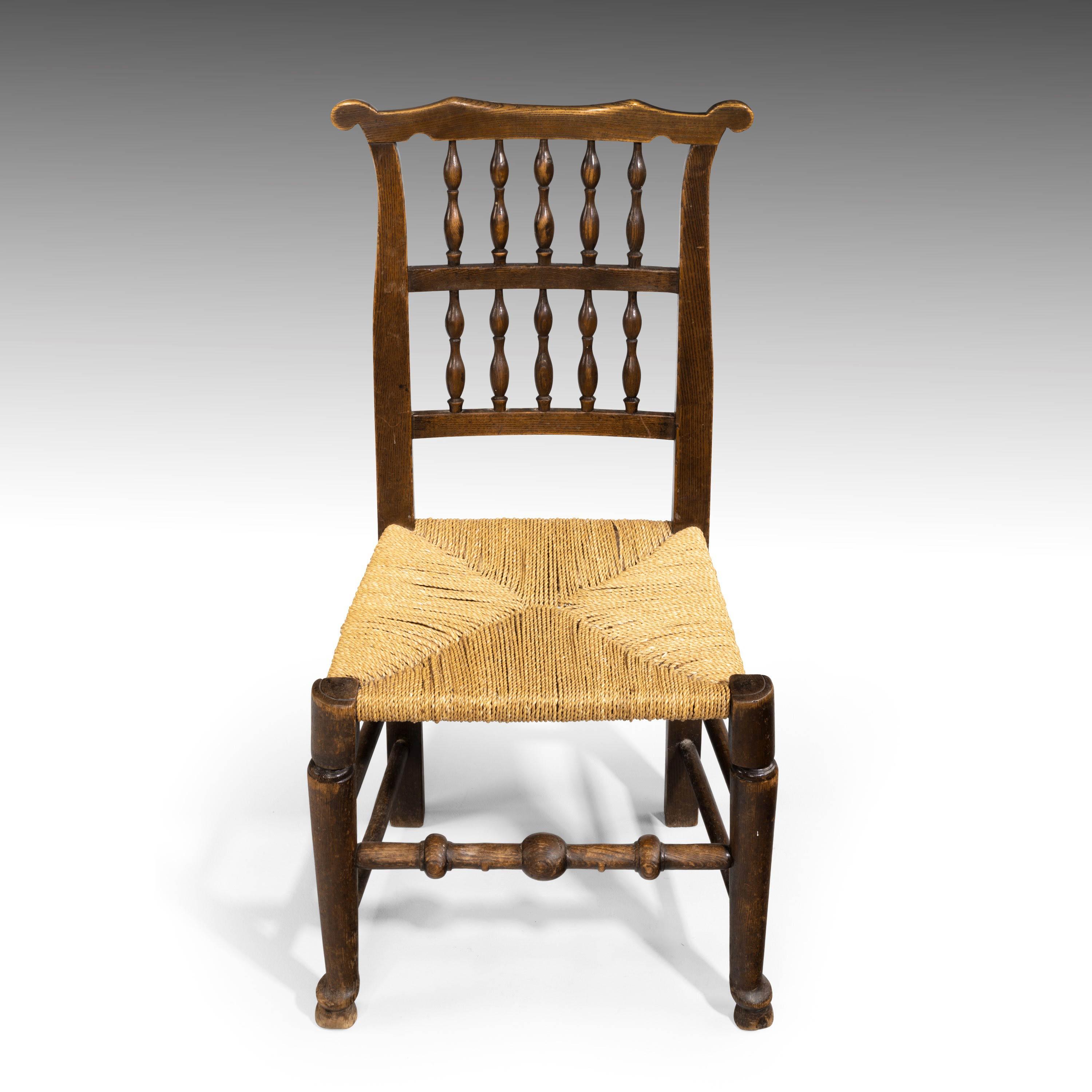 An attractive elm spindleback armchair with a rush seat, mid-19th century. Excellent overall conditional and patina. Measures: Seat height 16.5