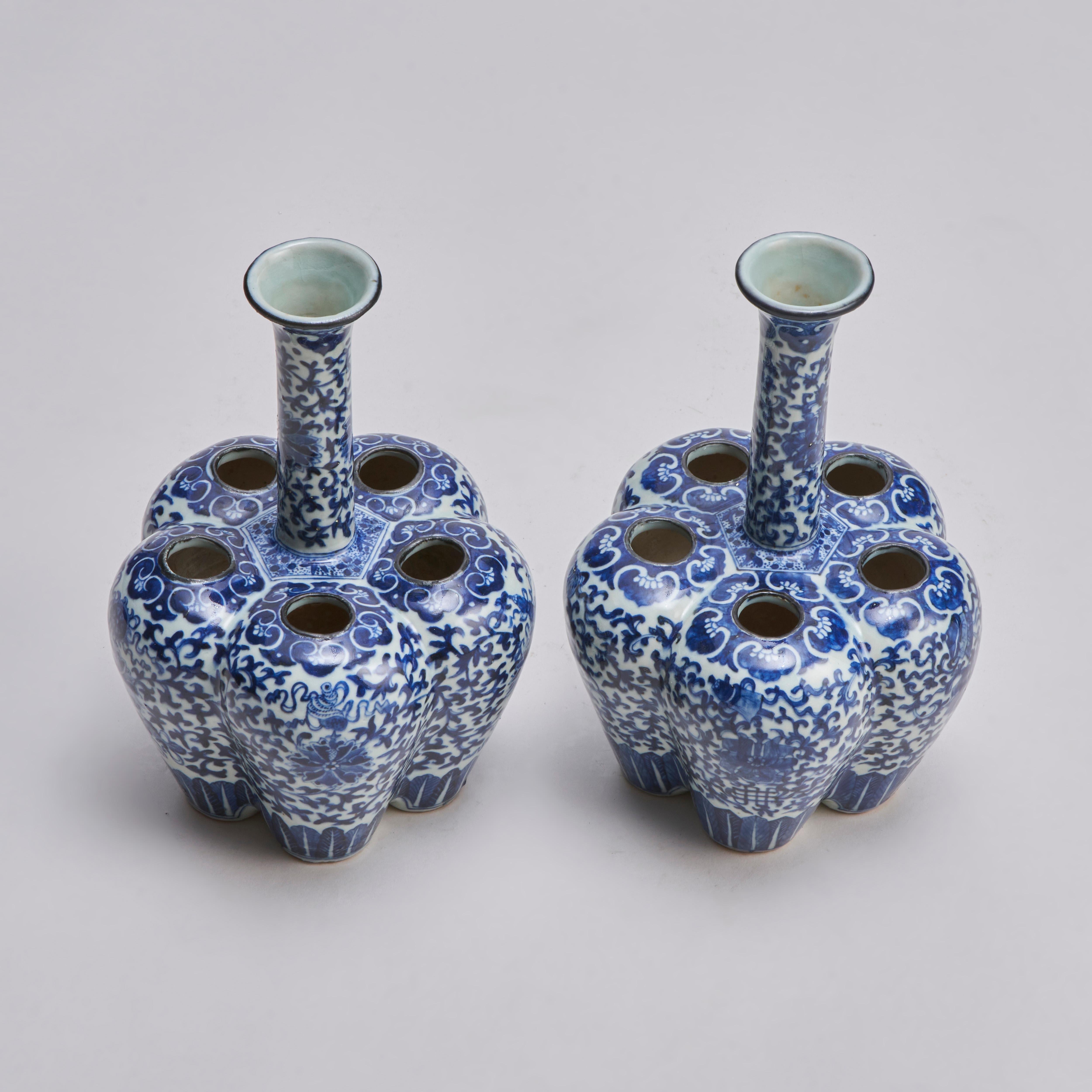 A pair of 19th century Chinese blue and white crocus vases formed of five smaller vases around a central neck with a flared rim. Decorated with clematis flowers on a foliate backgound with ruyi borders.

Contact us for further information, images or