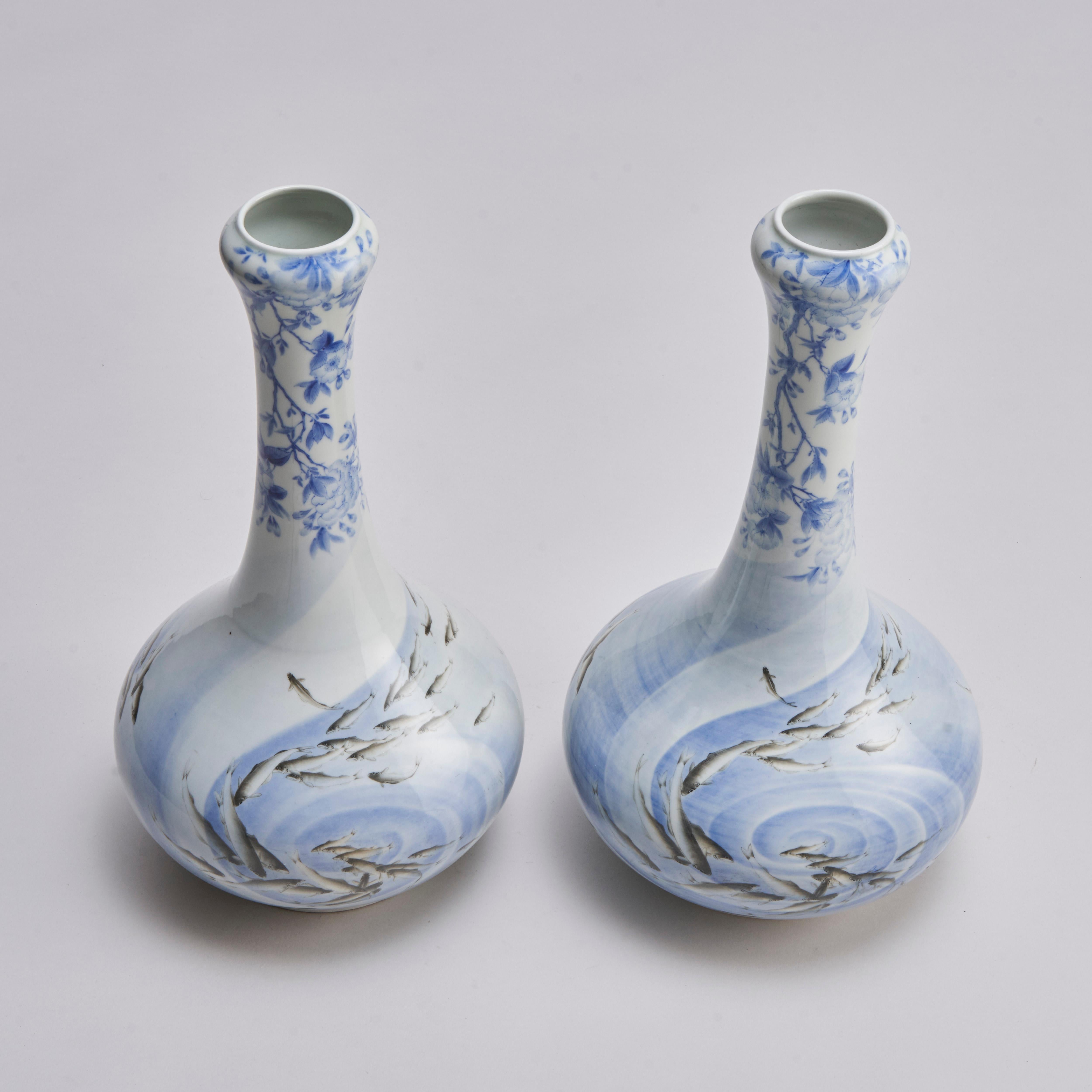 A pair of early 20th century Japanese bottle vases, with an elegant blue and white cherry blossom design to the neck and a swirling whirlpool with realistic swimming grey salmon.
Contact us for further information, additional images or to arrange a