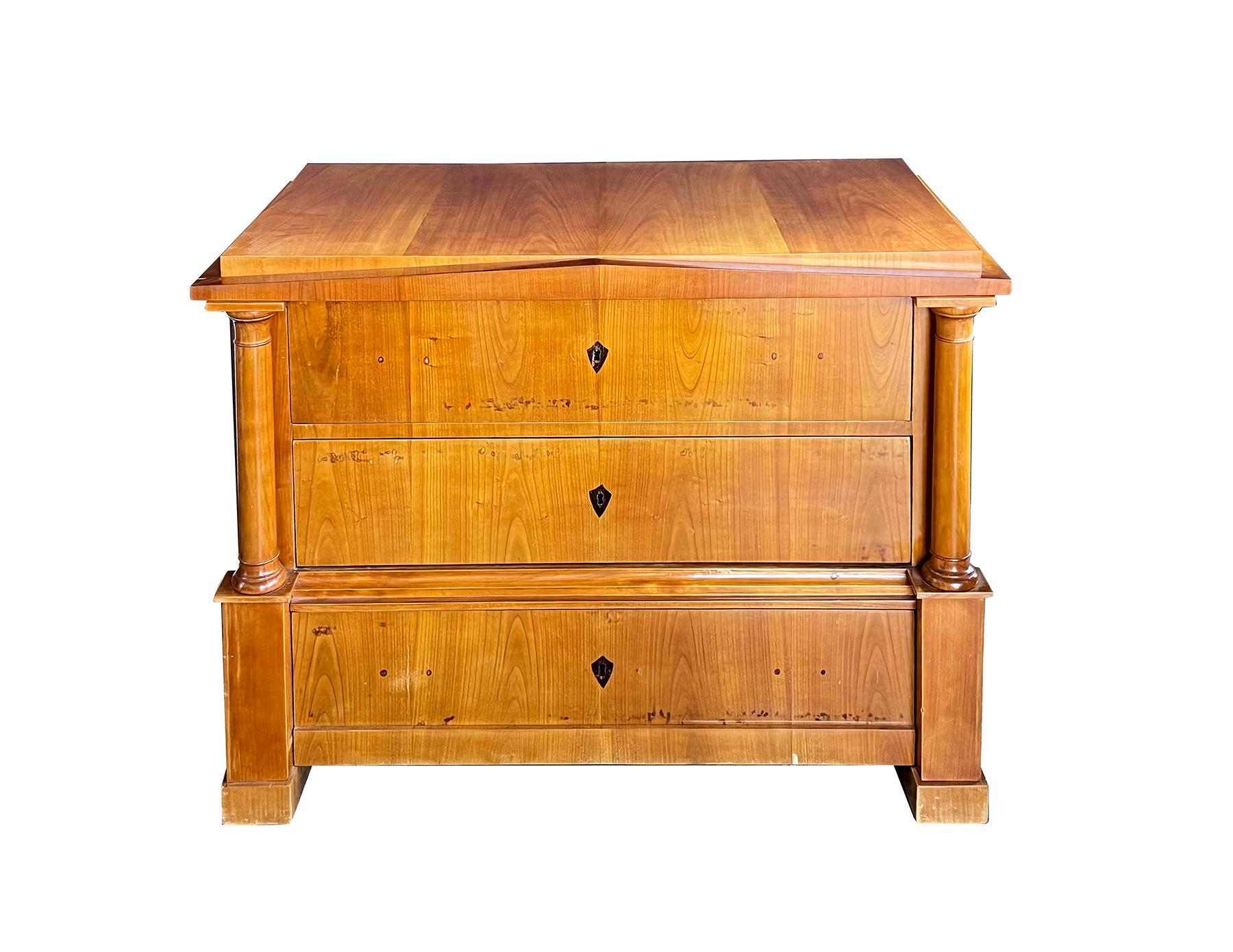 this rare architectural or pyramid Biedermeier furniture was created by the highest level craftsmen, having a rectangular top above a pediment frieze over three drawers flanked by Doric columns over block supports