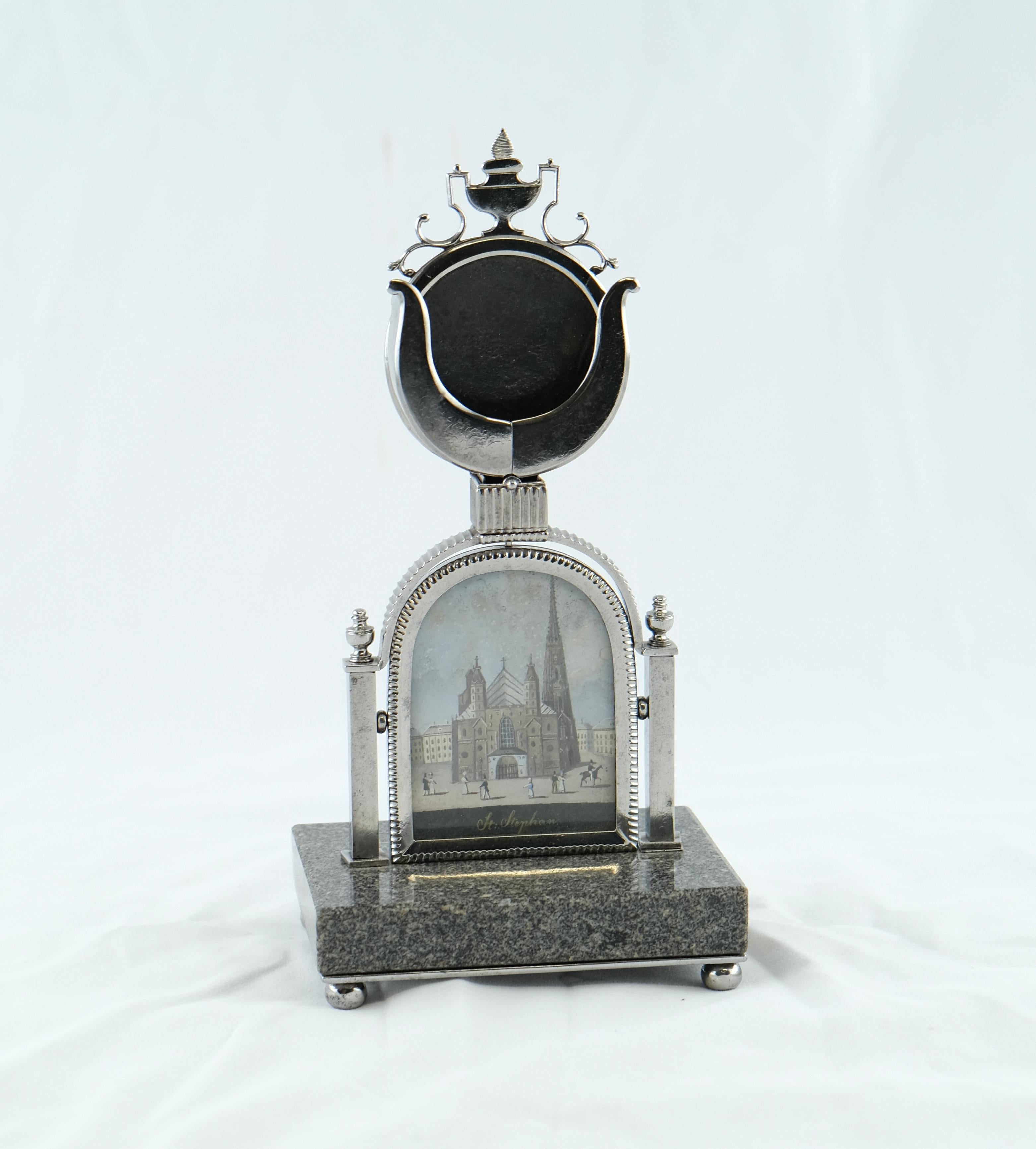 A beautiful and exclusive clock stand made of steel and granite. Holding a picture of the Stephans-dome. The most famous church in Wienna, Austria.
High quality craftsmanship on all details. A gem.