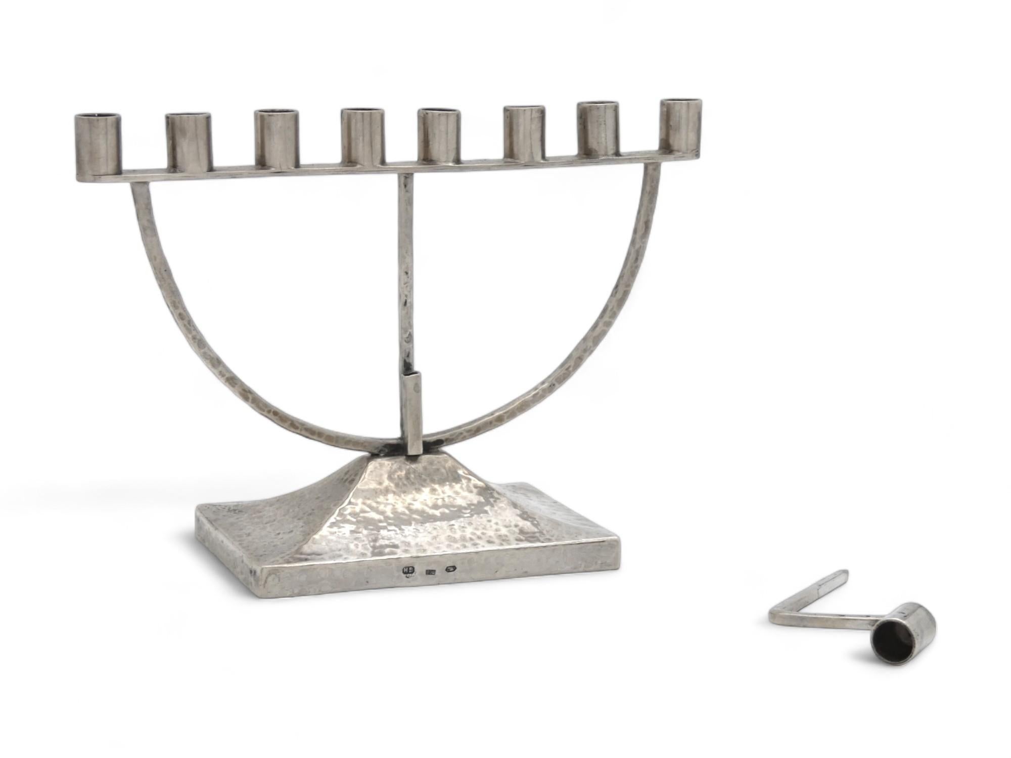 An Arts and Crafts Austrian Hanukkah Lamp made for Children, Circa 1925.

The hammered base and both curved and straight shafts with the overall geometrical shape of this Hanukkah menorah suggest signs of designs on pieces that were created in the