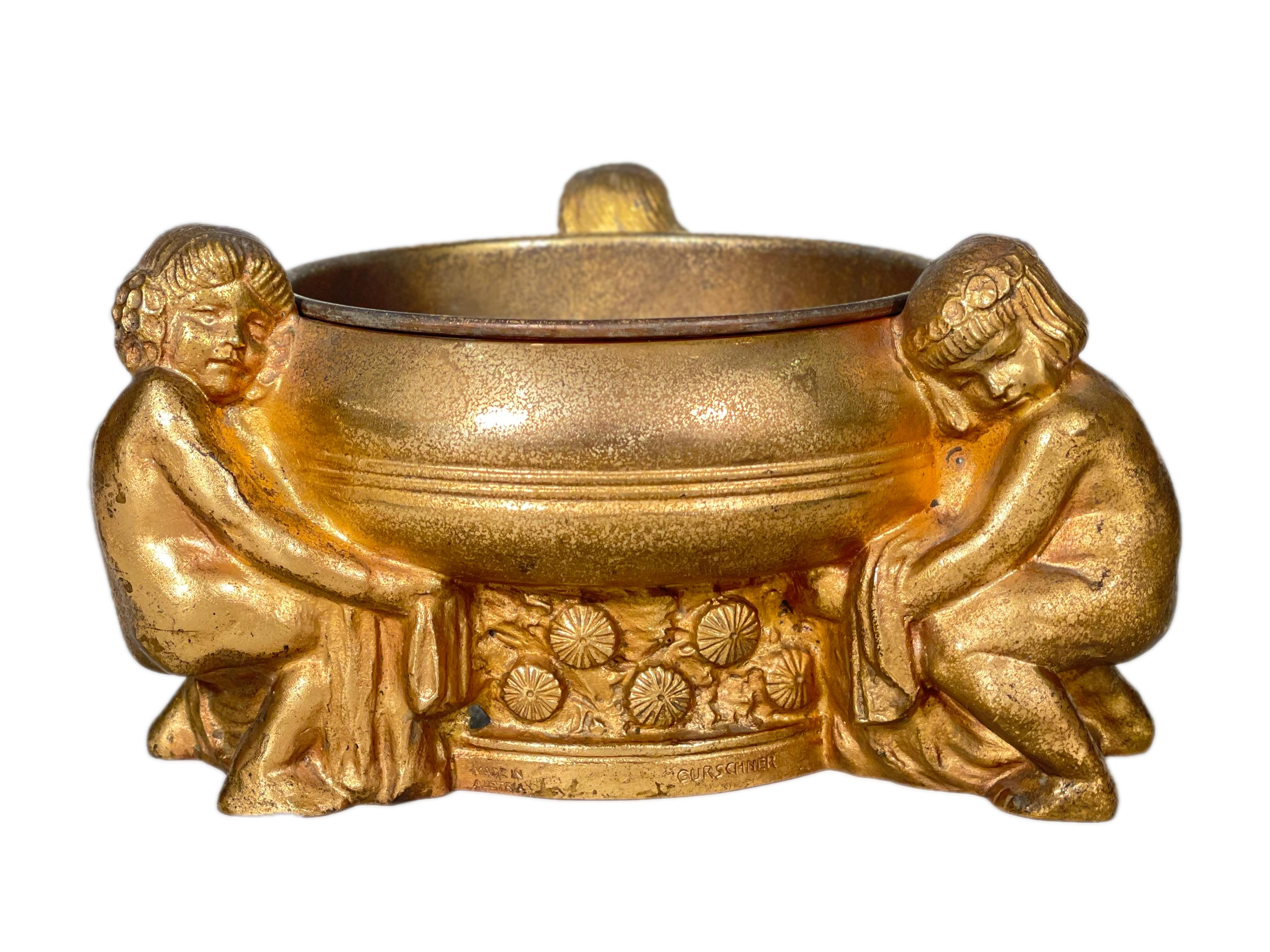 Austrian Art Nouveau cast and gilt bronze figural jardinère by, Gustave Gurschner decorated with three young maidens holding a bowl. The jardinère is finished in its gold doré patina further acid etched giving the sculpture further texture