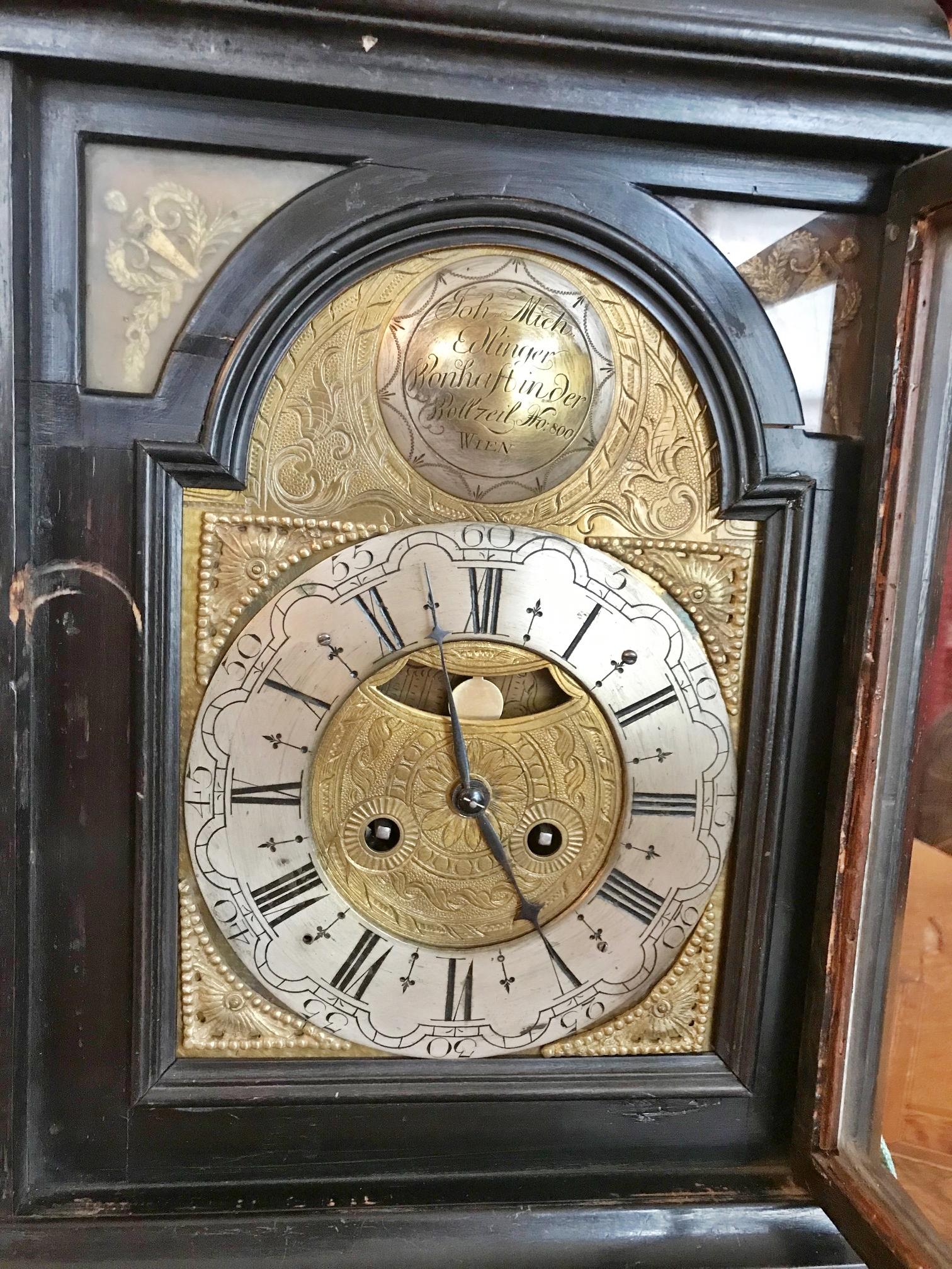 Austrian ebonized table clock ( Bracket Clock), backside engraved brass movement, spring mechanism, spindle escapement, duration 1 day, half hour strike on the bell, engraved shield arch brass dial, four-sided glazed two-door wooden case, bronze