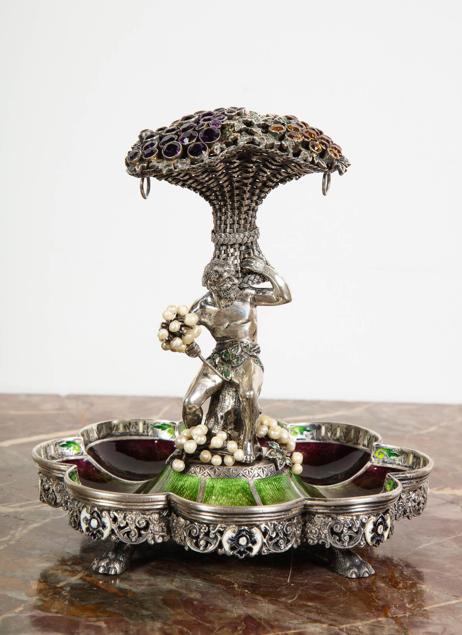 An Austrian / Viennese silver, enamel, and gem-set Tazza centerpiece,
circa 1900.

Set with amethysts, citrines, emeralds, and freshwater pearls, unmarked

Good condition. Minor scratch to interior enameling in 1 area (see photo)

Measures: 6