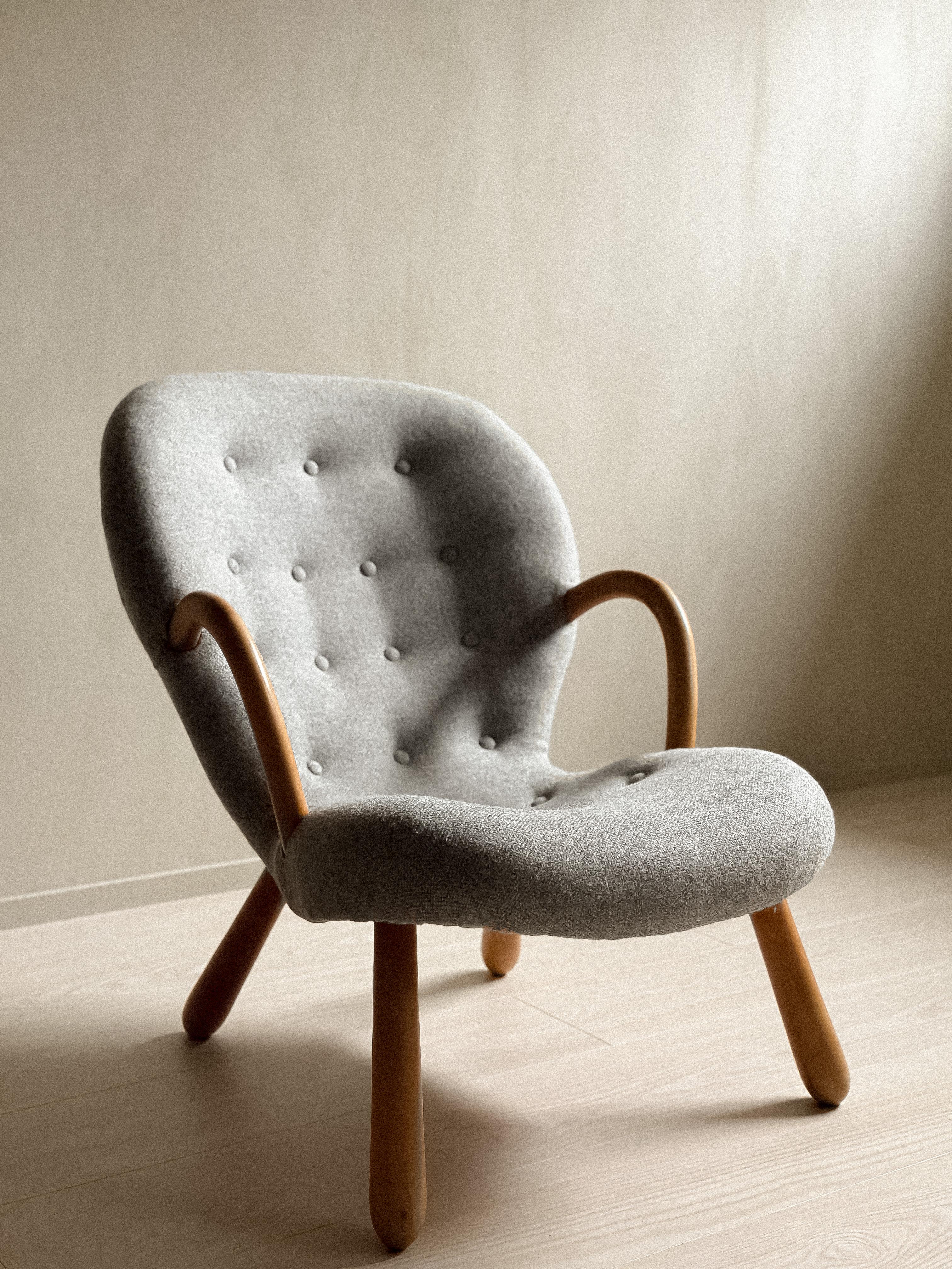 A Vintage and authentic Clam Chair by Arnold Madsen produced by Vik & Blindheim in Norway, 1953. The chair has been later upholsterd in a light grey wool fabric. It can be re-upholstered to meet your preferences.