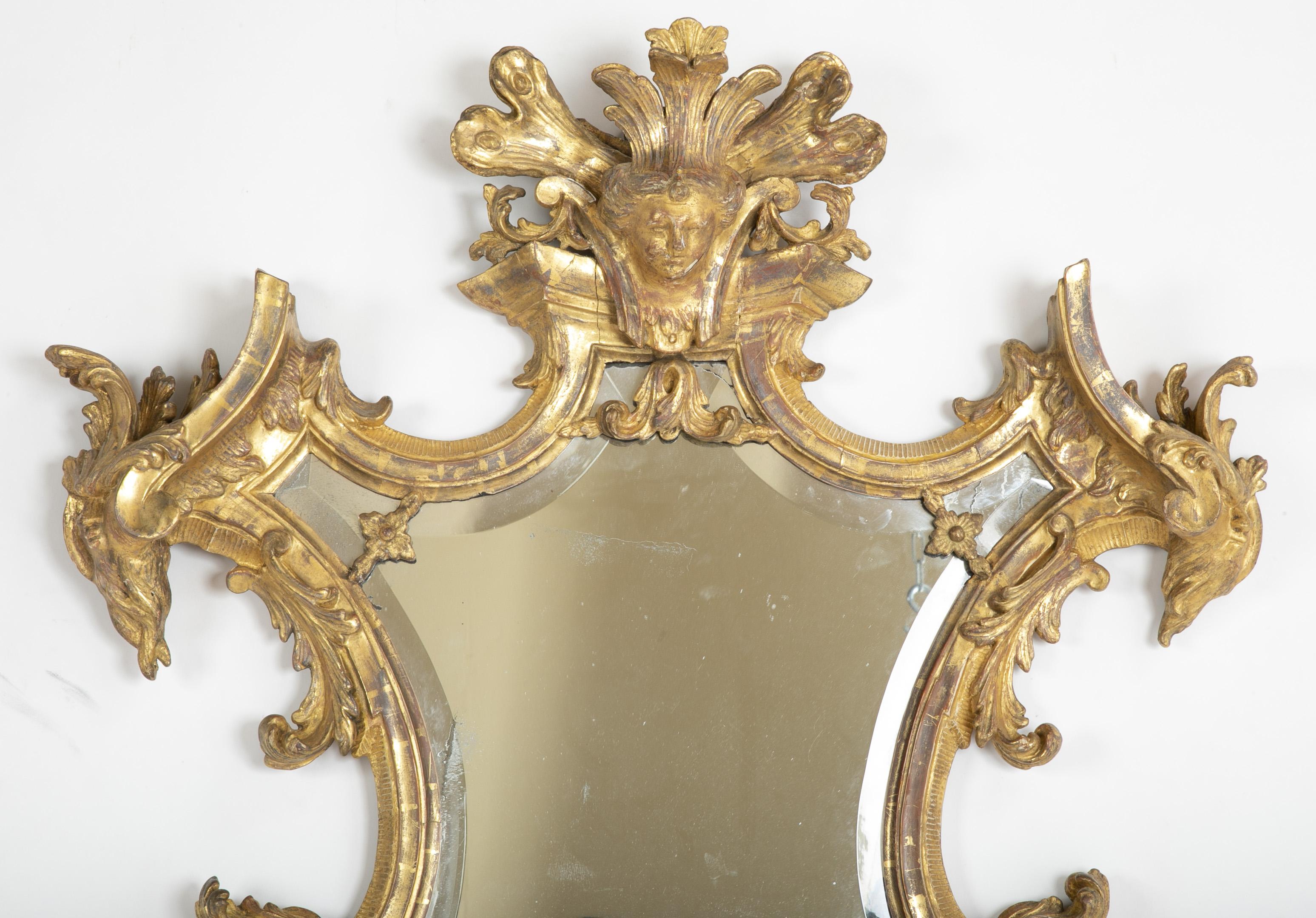 An Italian baroque mirror mid-18th century with beveled glass mirror.