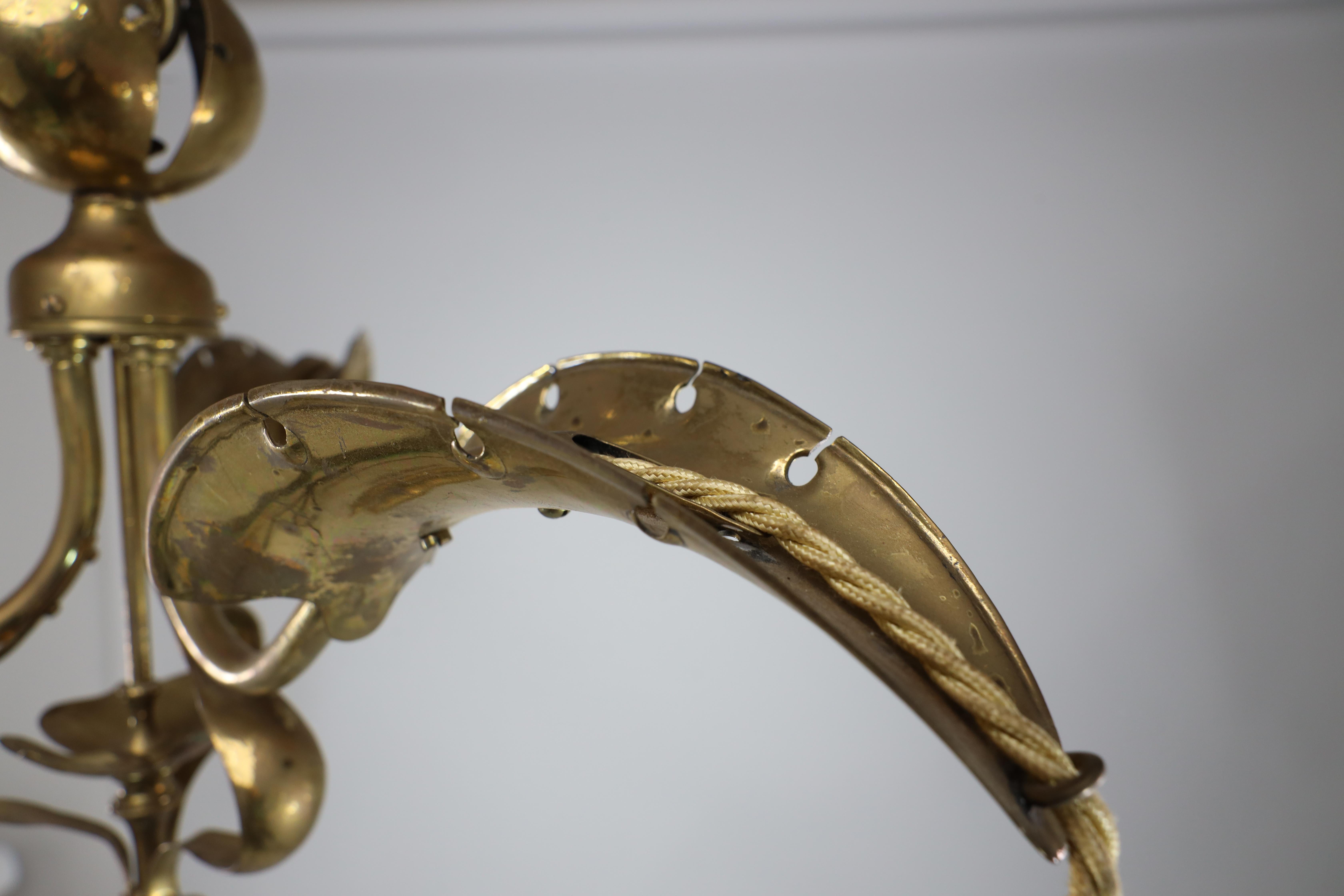 A brass three arm ceiling light with a central shaped sphere & leaf decoration For Sale 1