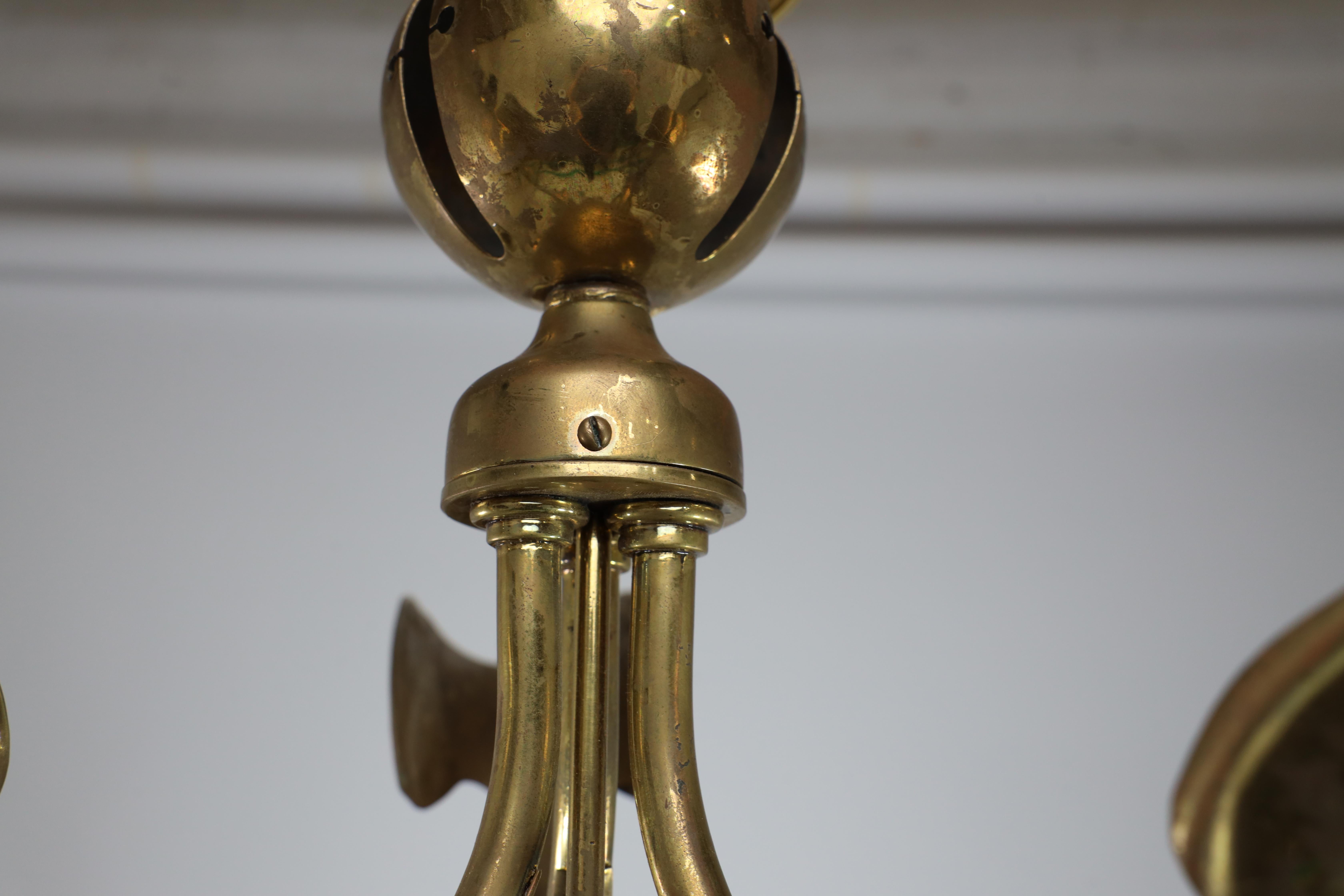 Early 20th Century A brass three arm ceiling light with a central shaped sphere & leaf decoration For Sale