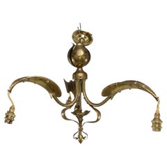 A brass three arm ceiling light with a central shaped sphere & leaf decoration