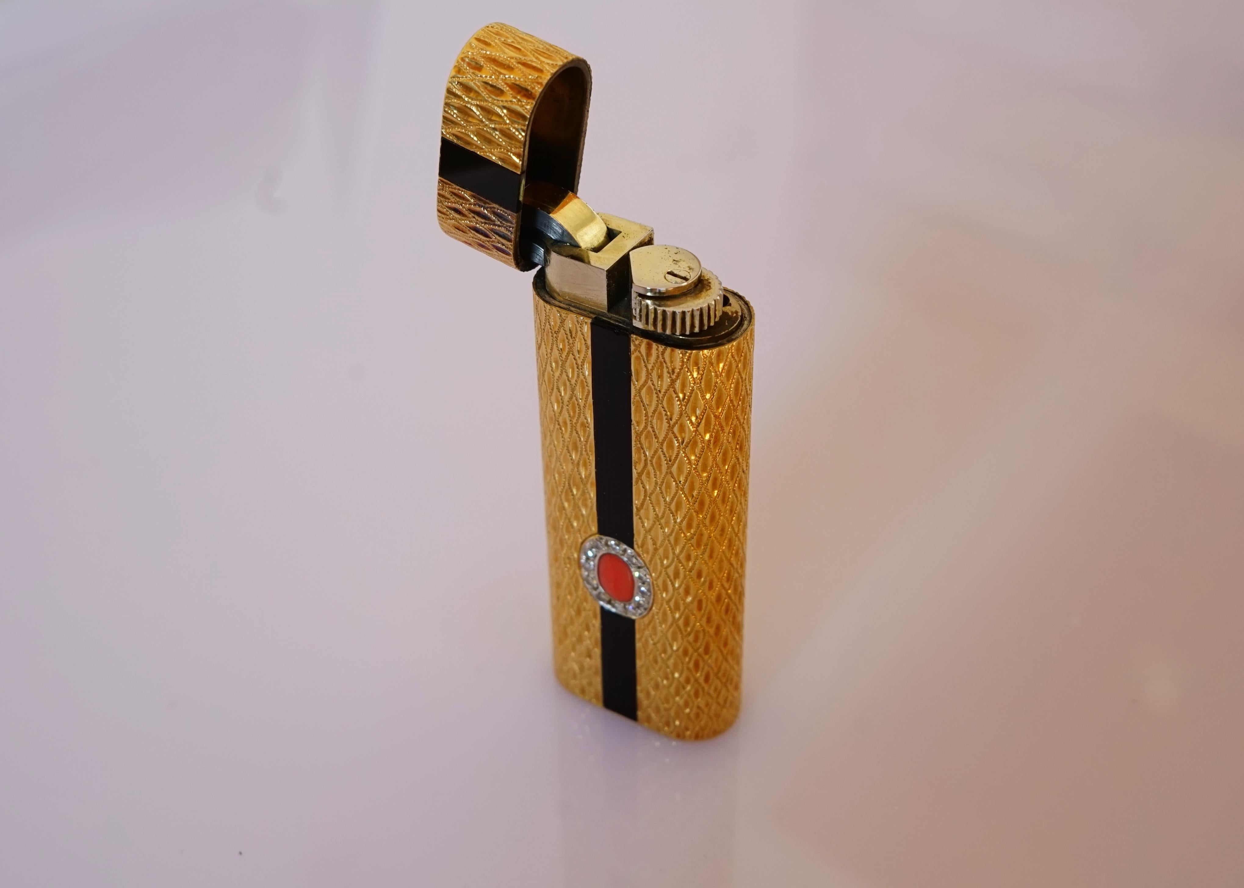 A beautiful lighter from Cartier with 18K gold, diamonds, and their classic black onyx, coral combination.

Please watch the video for the full details.