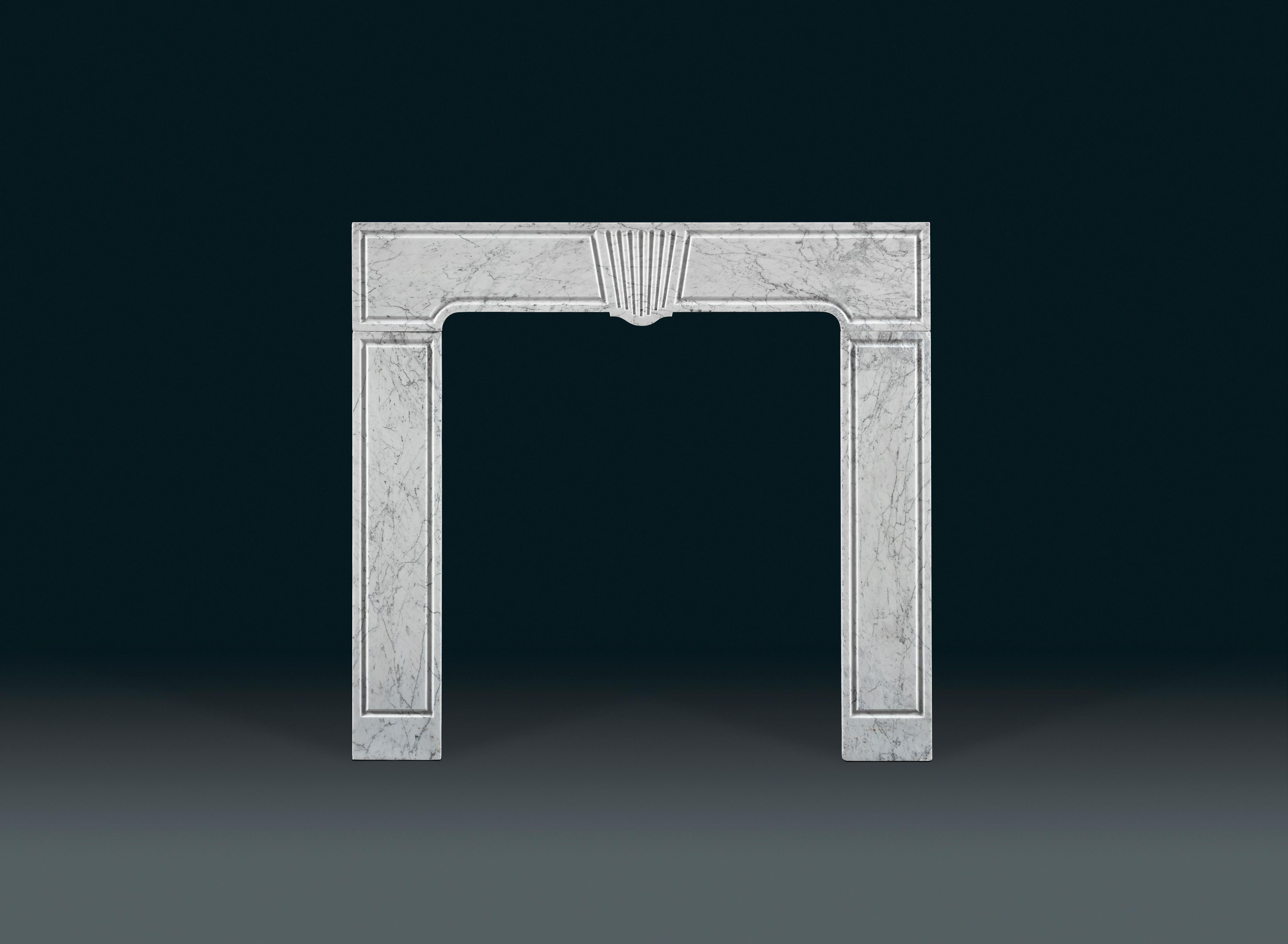 An early 18th century Carrara marble fireplace, the frieze decorated with a central keystone with graduated flutes, the sides and jambs with simple incised geometric mouldings, circa 1710, see Georgian, Chimneypieces, Georgian Group, Neil Burton,