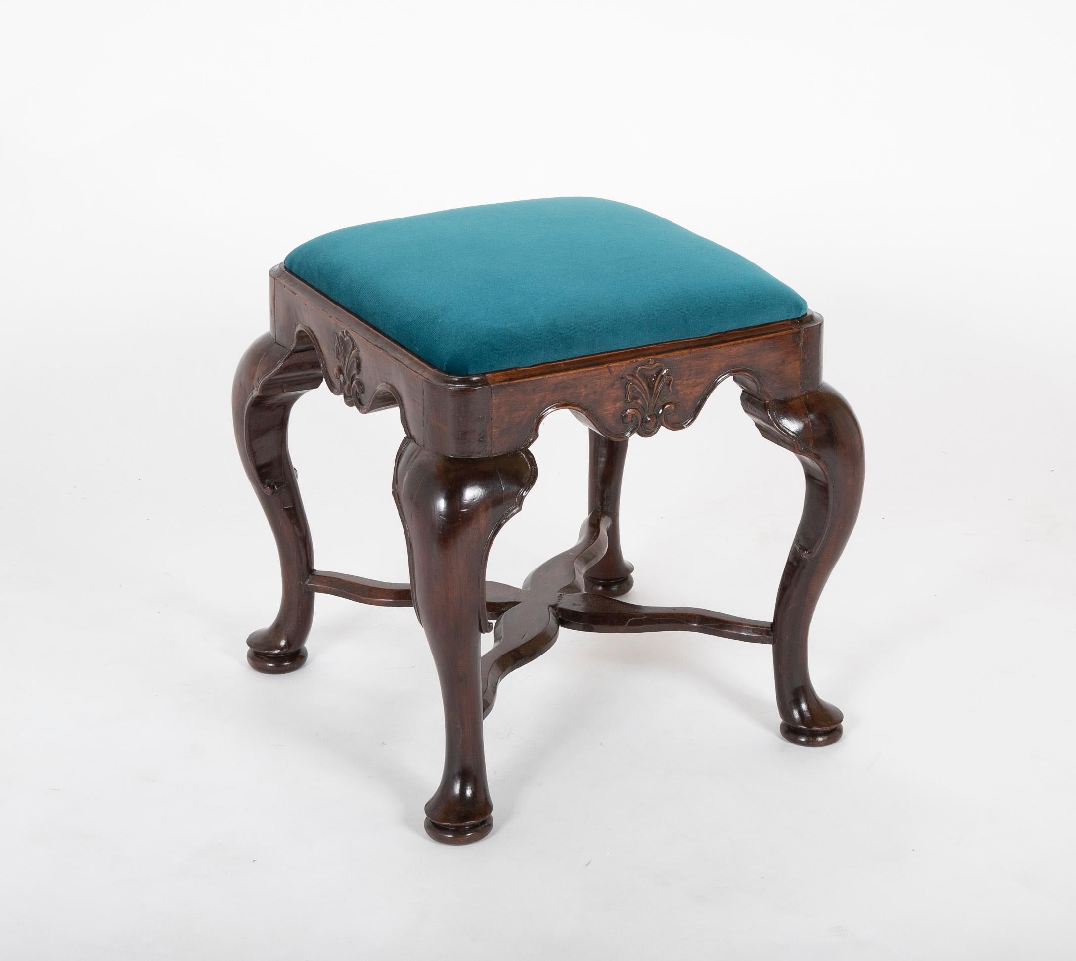 An early 18th century English George II deeply carved footstool.