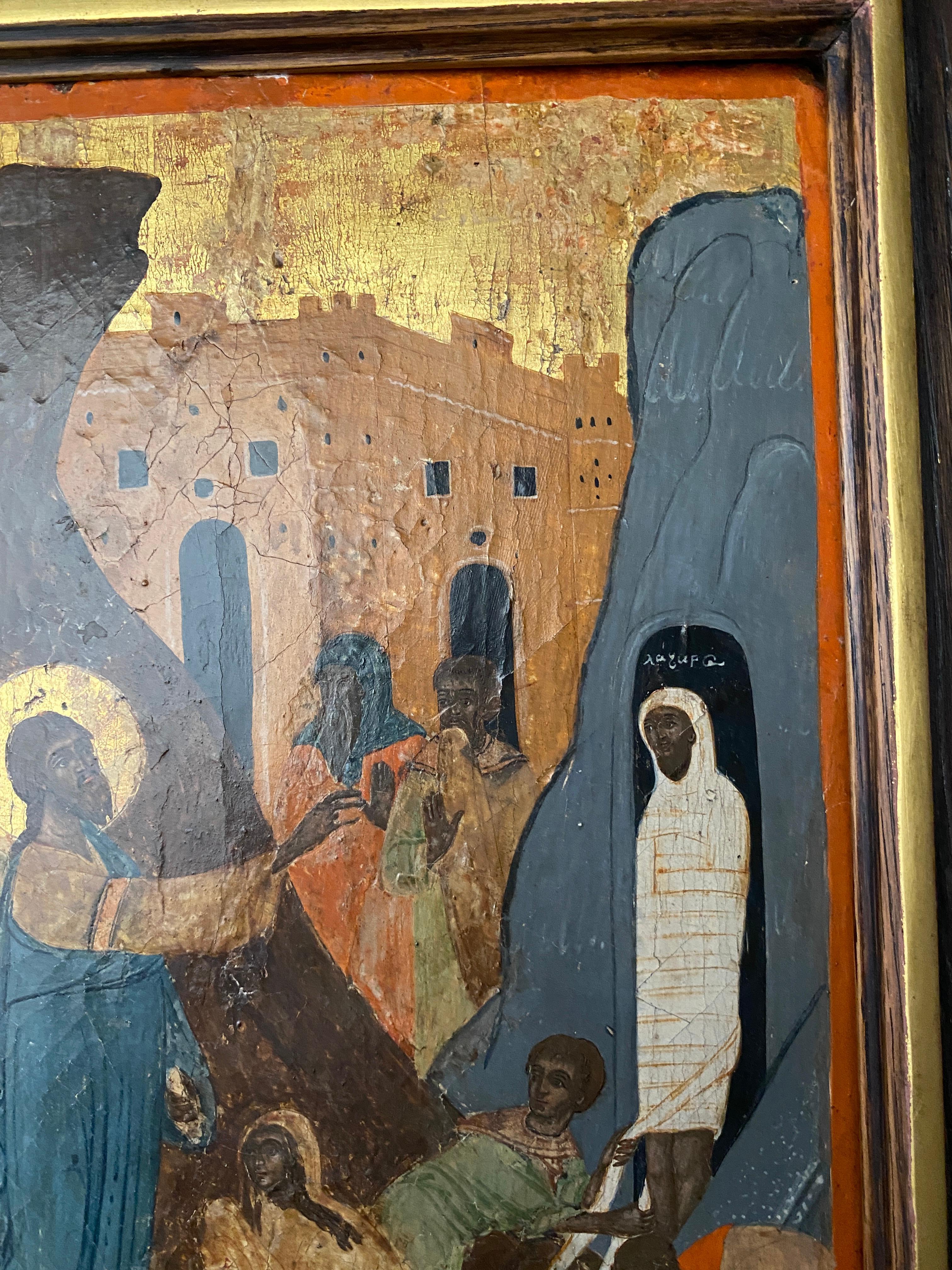 An early 18th century Greek Provincial icon of The Raising of Lazarus
Within a later wooden frame, 38.2cm high x 23.3cm wide.
Christ followed by His Apostles in shown approaching the tomb of Lazarus, which is set in a ravine that opens onto a view