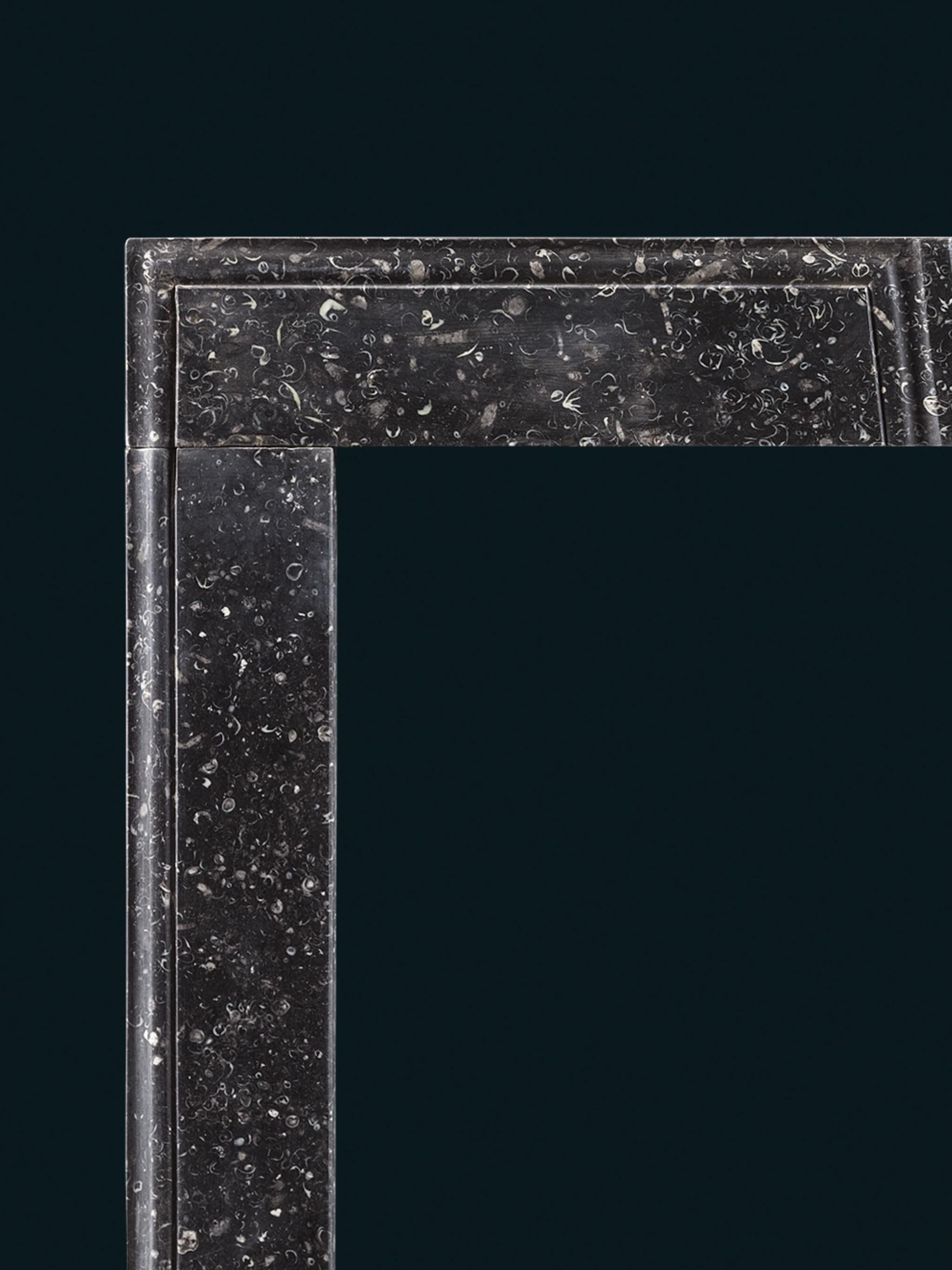 Carved An Early 18th Century Irish Frame Chimneypiece in Kilkenny Fossil Marble For Sale