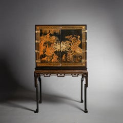 An early 18th century Queen Anne japanned chinoiserie cabinet on stand.