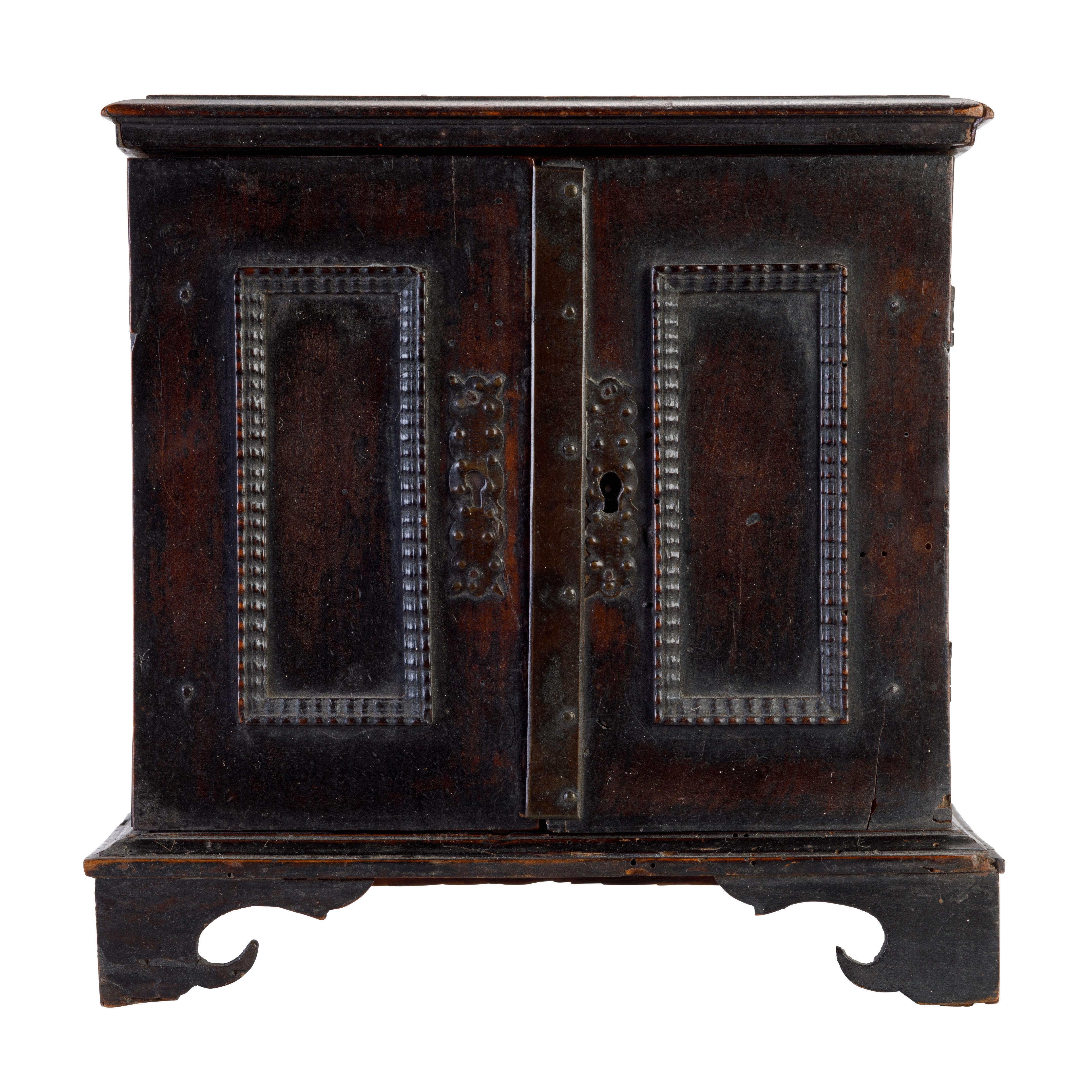 A fine early 18th century walnut table top jewelry cabinet, the doors opening to reveal mirrored glass drawers, with marbled paper linings.