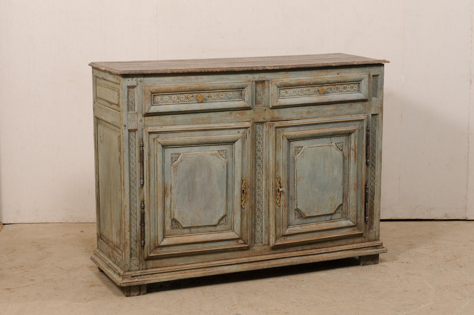 A French cabinet with faux marble painted top from the early 19th century. This antique buffet from France features a slightly overhanging rectangular-shaped top (brown colored faux marble), above a case which houses a pair of recessed panel drawers