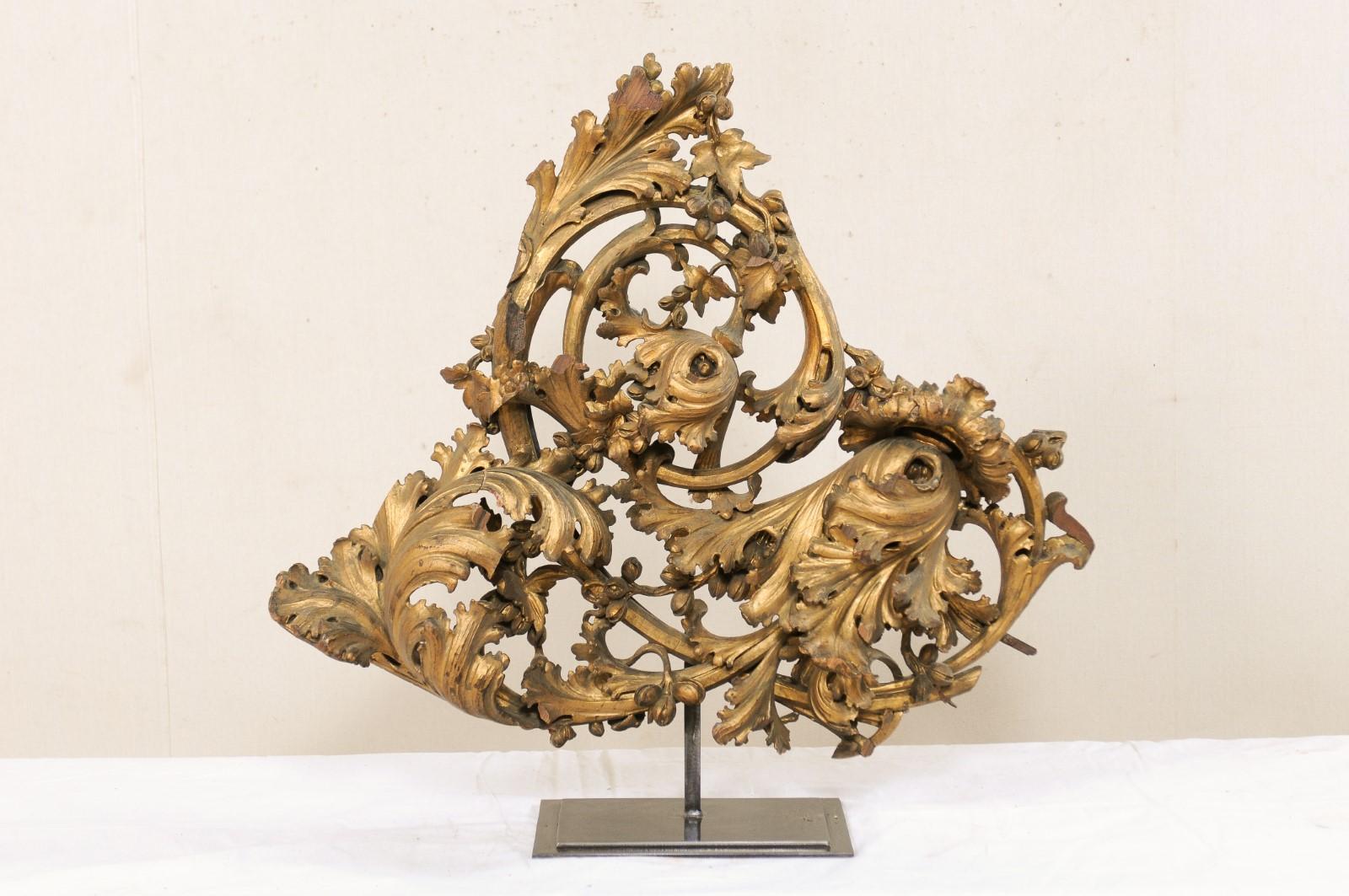 An Italian pierce-carved and giltwood fragment from the early 19th century, mounted on custom Stand. This antique wooden fragment from Italy has been heavily hand carved in a pierced and three-dimensional scrolling acanthus leave motif. This piece
