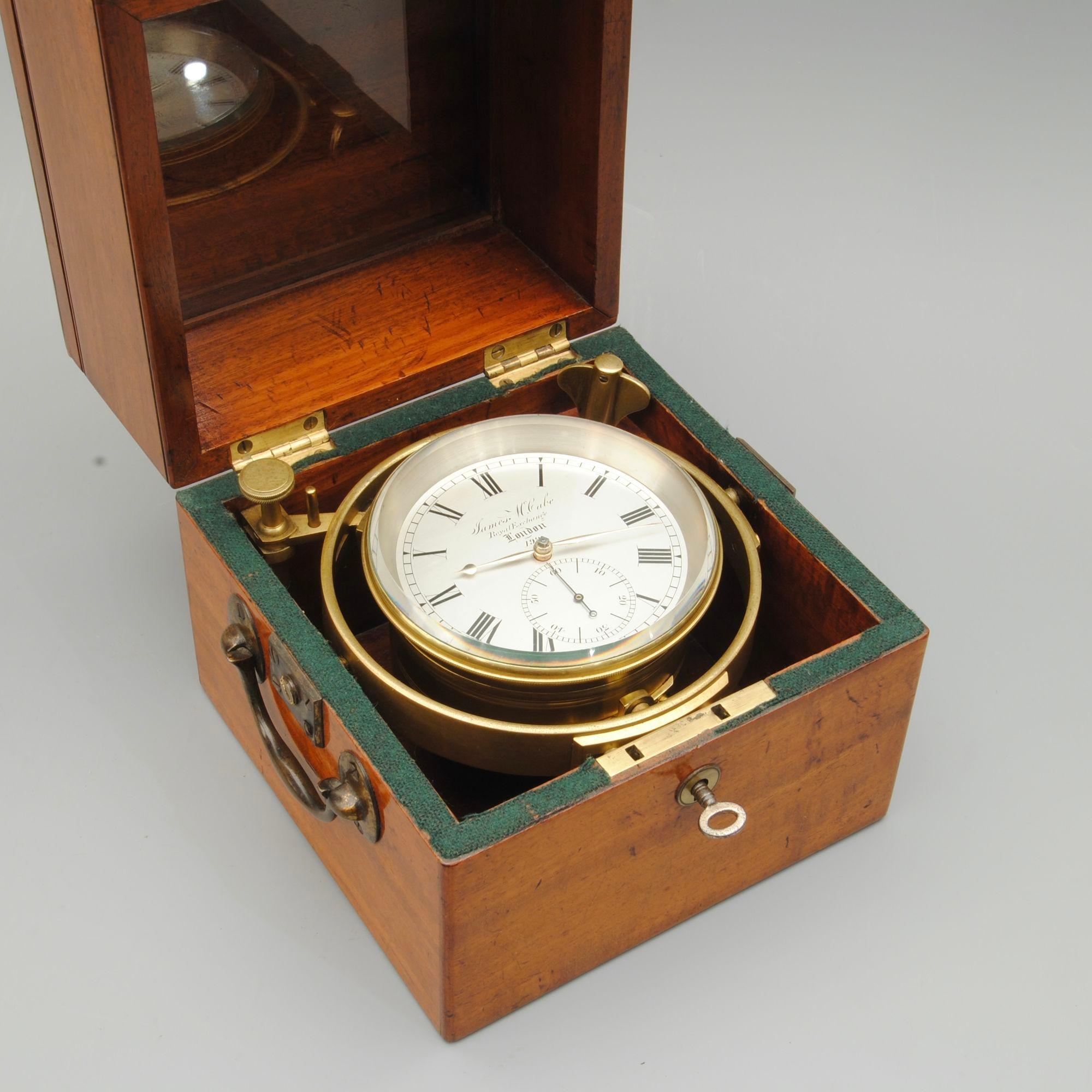 Number 199, a two day marine chronometer by James McCabe, London, beautifully signed and numbered on the dial and movement, and the number on the bottom of the bowl. In a three part mahogany case now with an enamel plaque. 
Unusually this fine